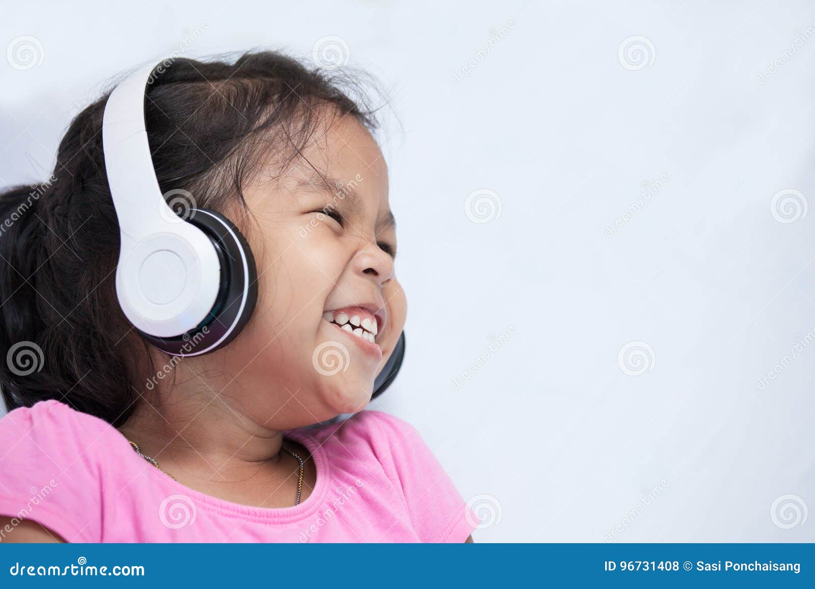 Cute Asian Child Girl in Headphones Listening the Music Stock Photo ...