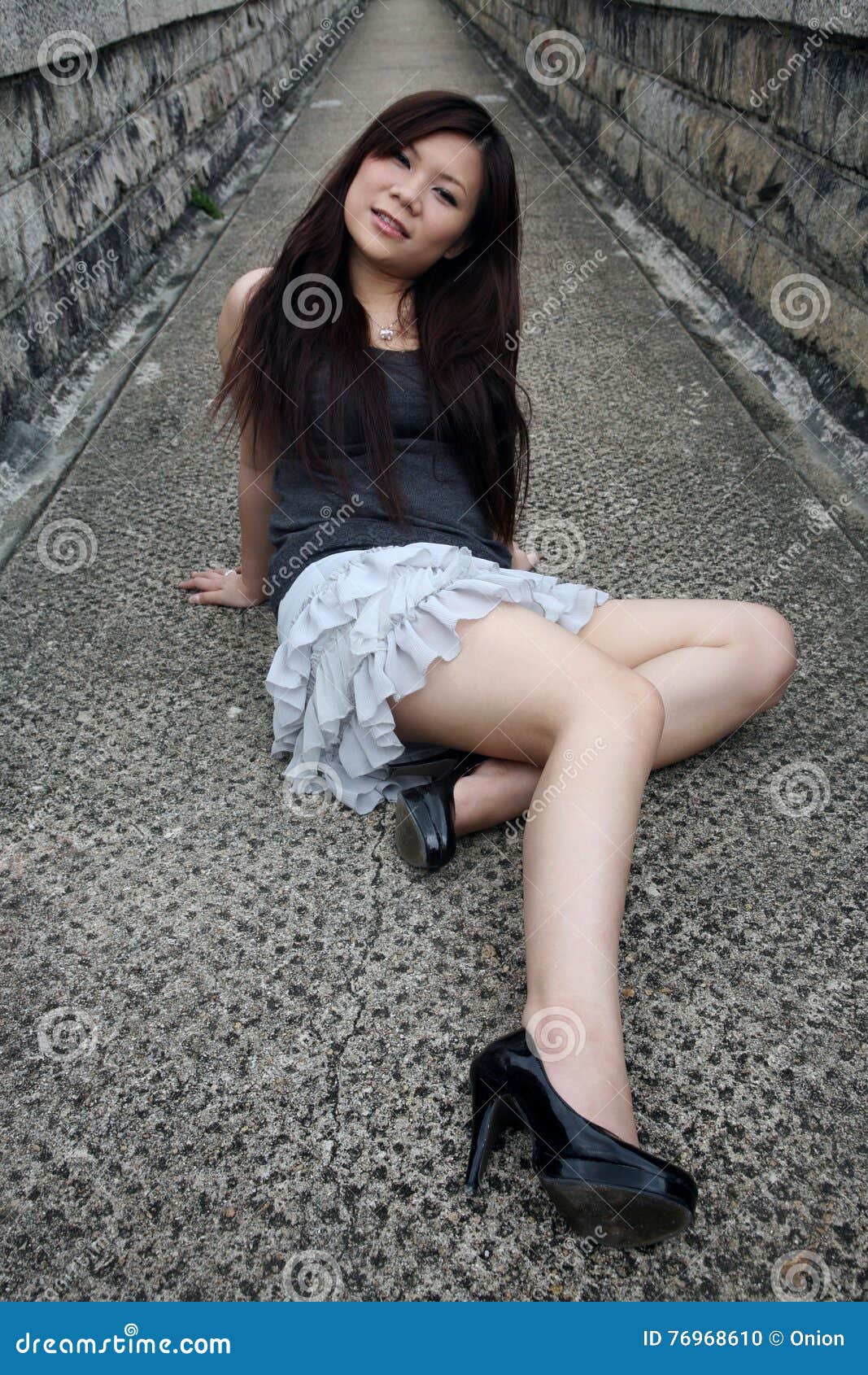 Low Section Shot Of Two Women Sitting On A Sofa One Woman Fastening Her  High Heels High-Res Stock Photo - Getty Images