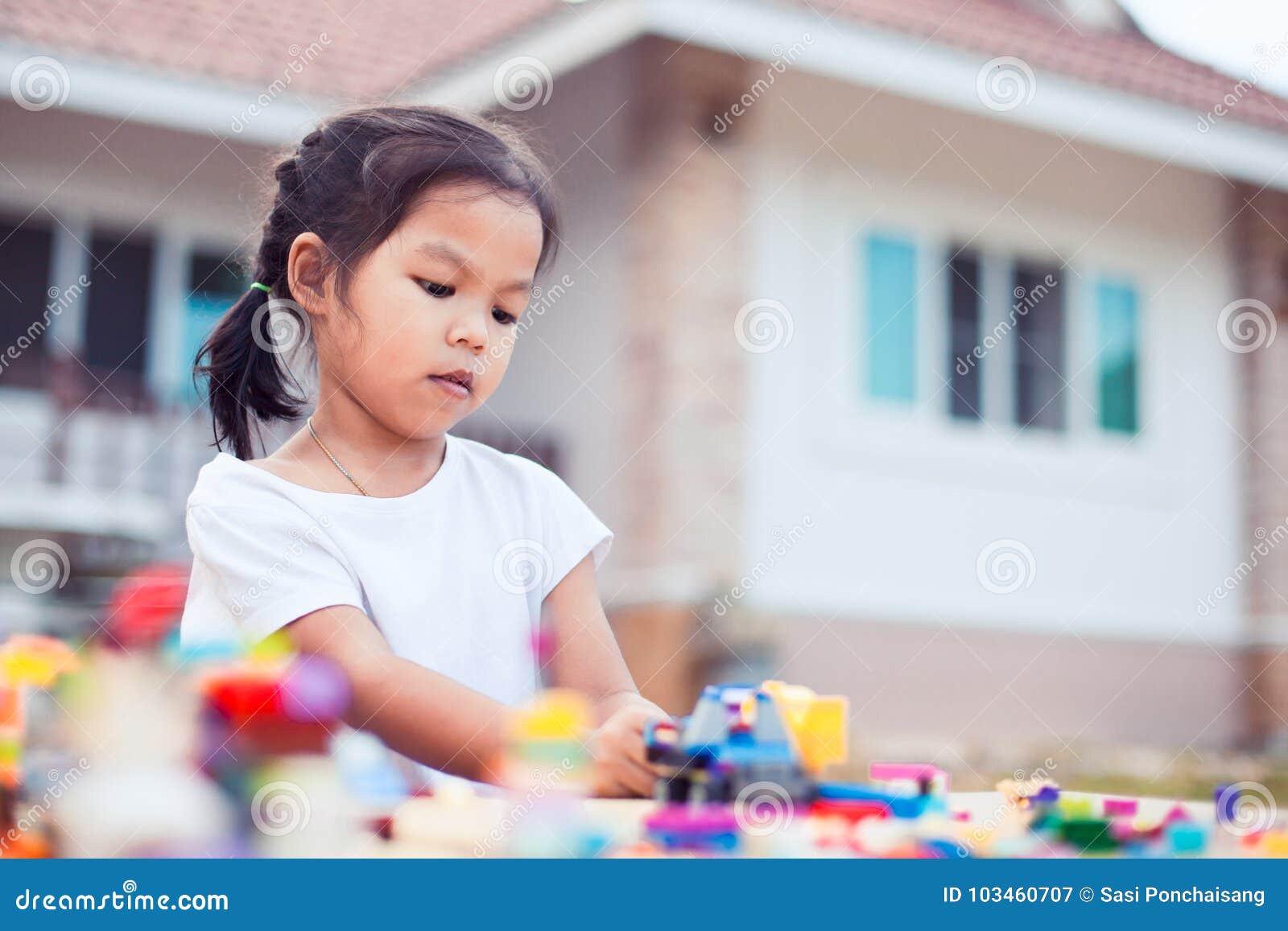 Cute Asian Little Child Girl Playing With Colorful Toy Blocks Stock