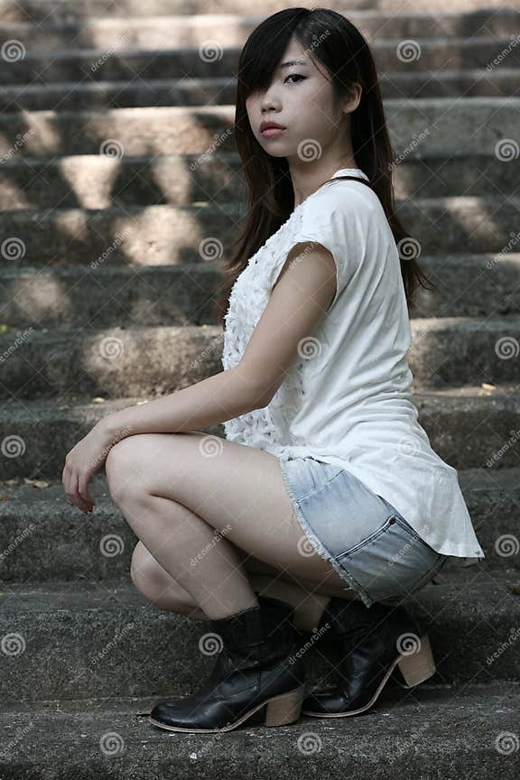 Cute Asian Woman In A White Top Looking At Viewer With Attitude Stock Image Image Of Carefree