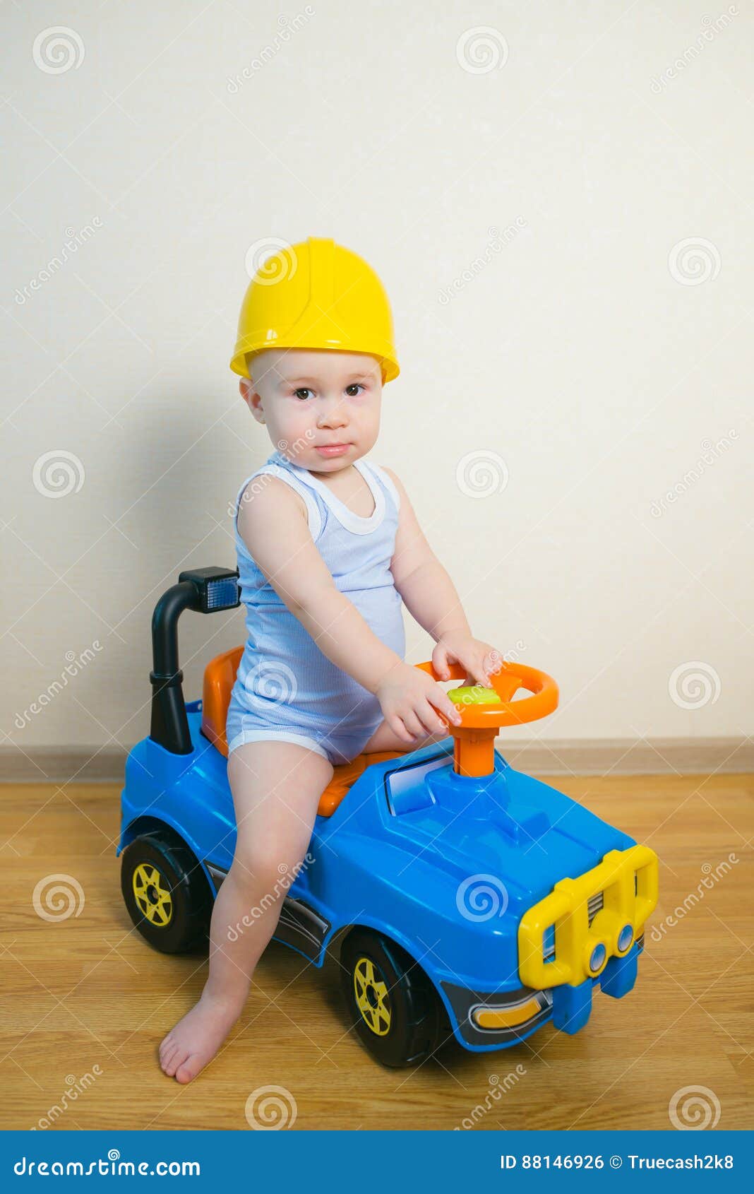 Cute Baby Boy Driving A Toy Ca