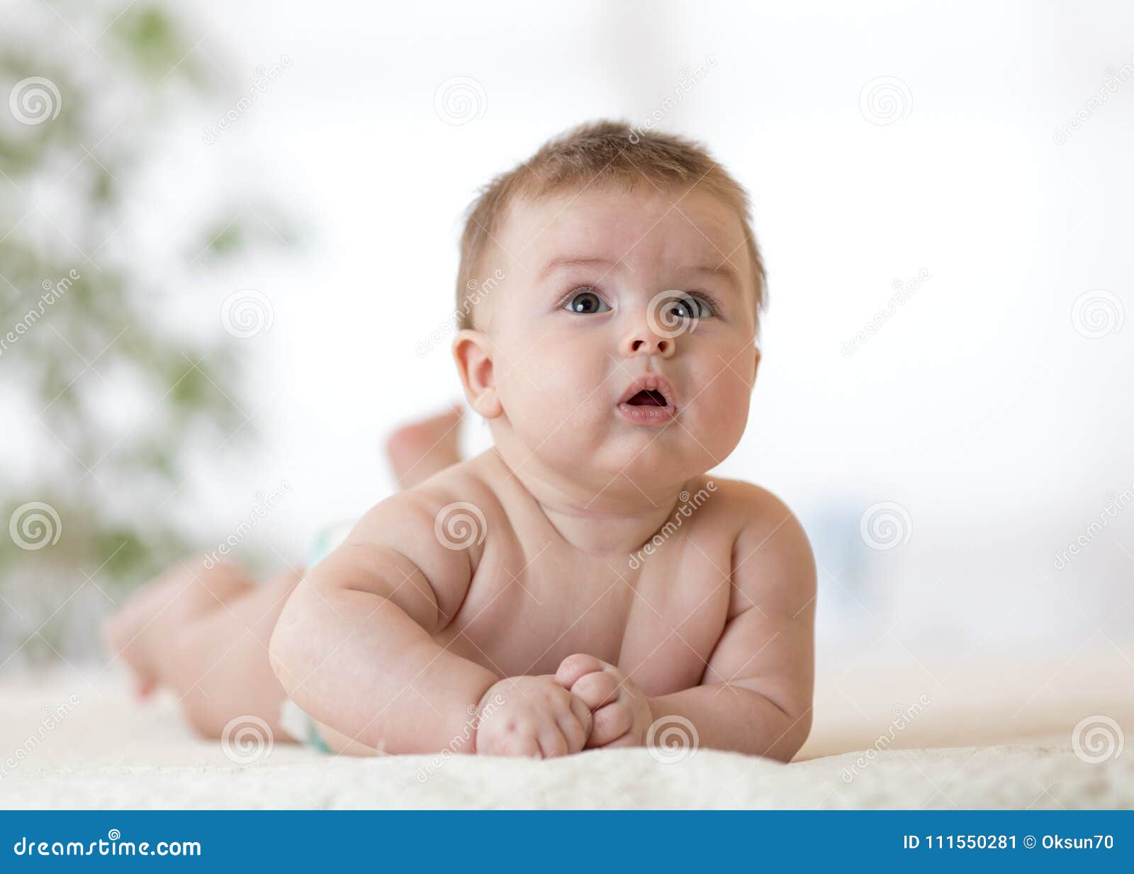 Cute baby boy laying down stock image. Image of interior - 111550281