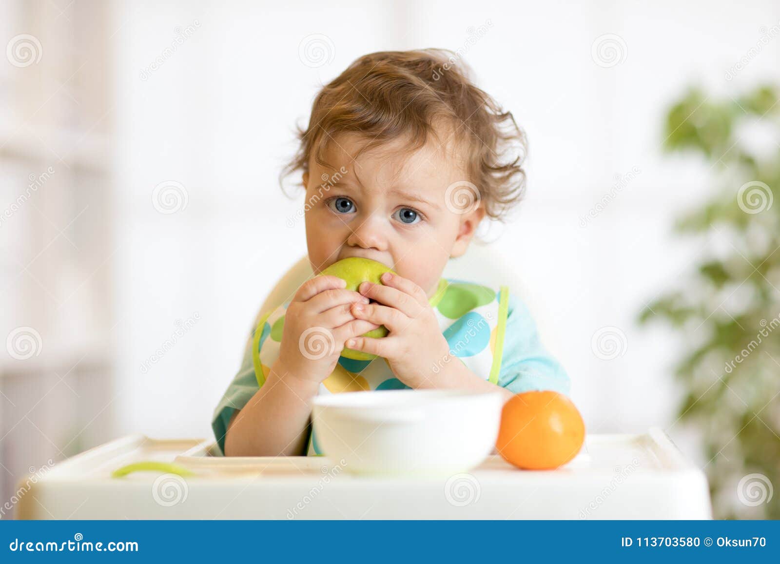 Cute Baby 1 Years Old Sitting On High Children Chair And Eating