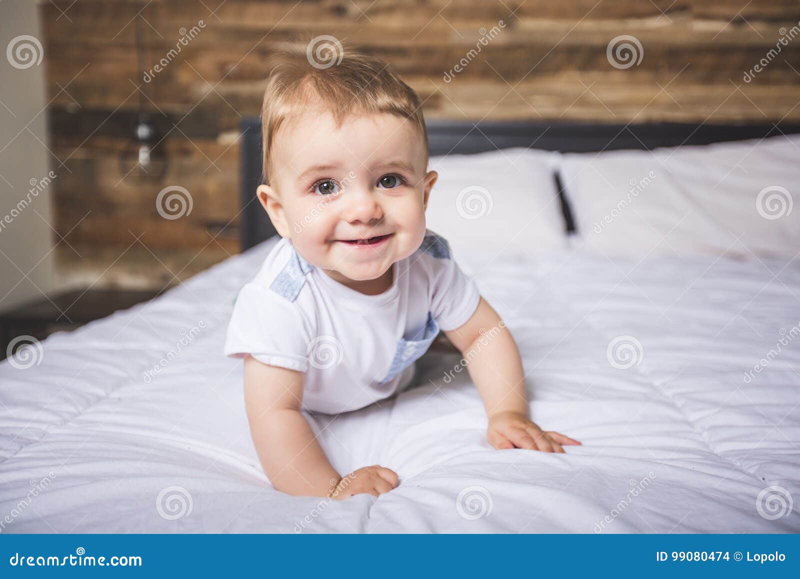 Cute Baby Boy in White Bedding. Stock Photo Image of expression