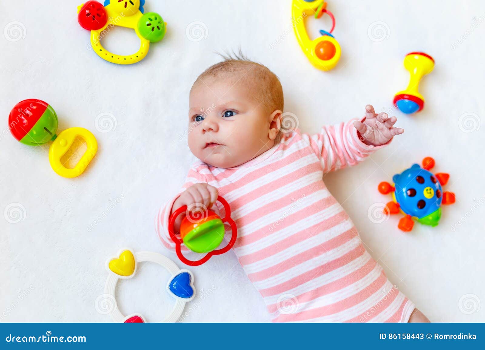 Cute Baby Girl Playing with Colorful Rattle Toys Stock Image - Image of ...