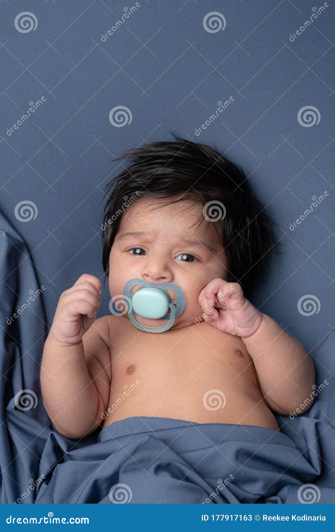 Cute Baby with a Nipple Looking at Camera Stock Image - Image of ...