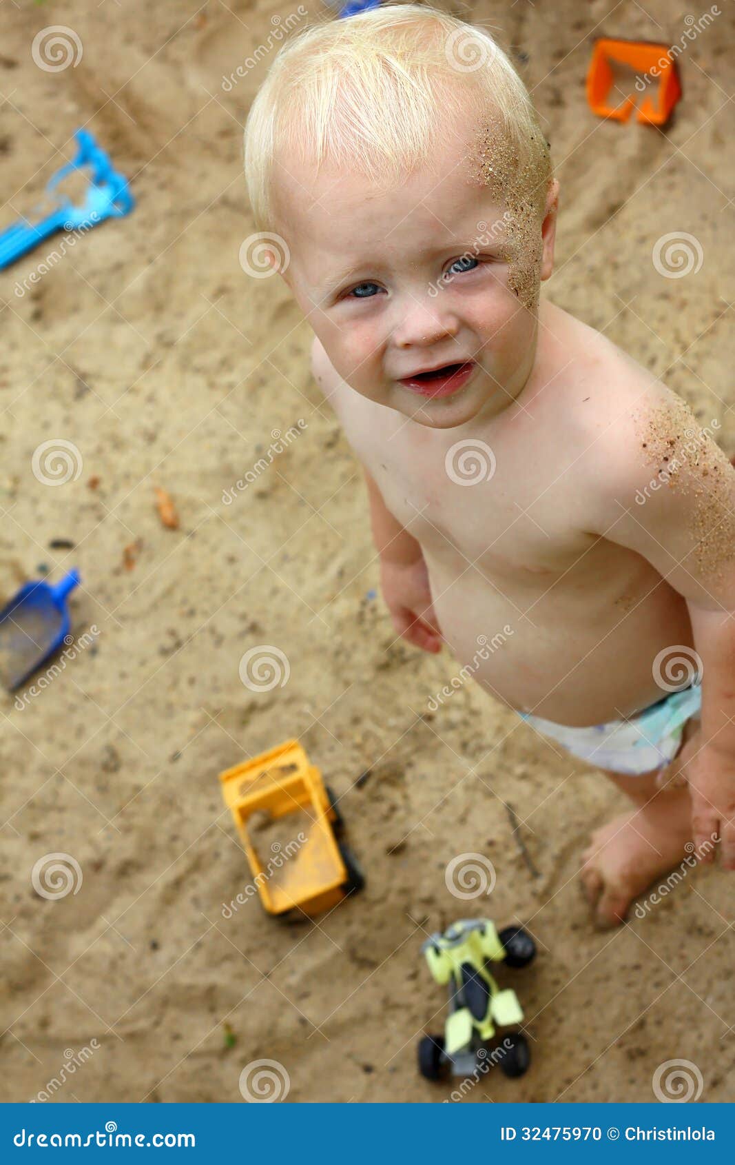 cute baby playing sand boy standing outside sandbox sunny summer day toys 32475970