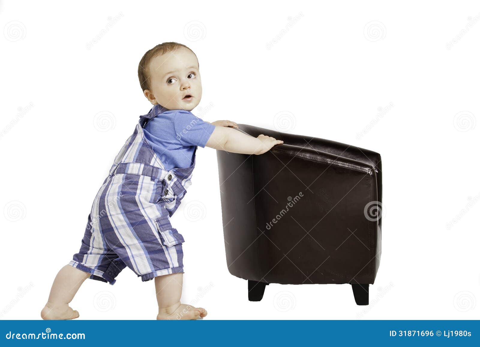 Cute Baby Pushes A Small Chair Stock 