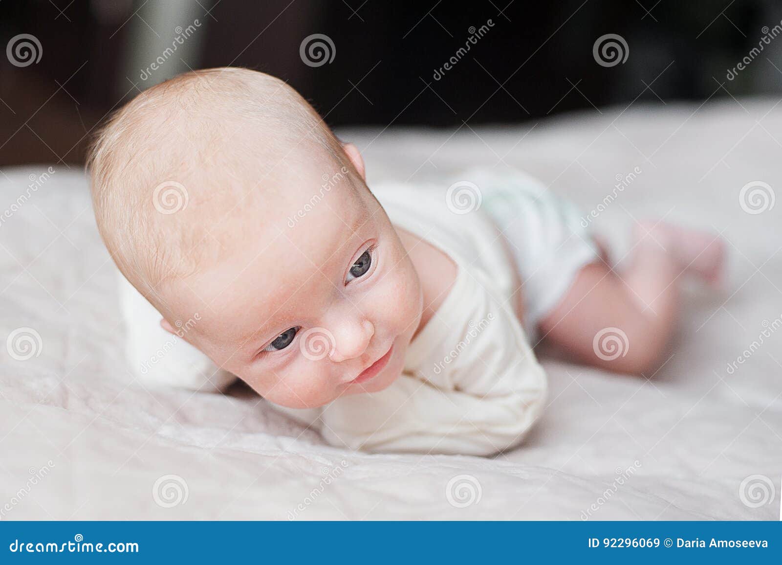 Cute baby on the white bed stock image. Image of little 92296069