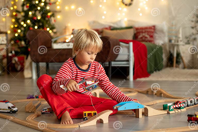 Cute Blond Child in Pajama, Playing at Home on Christmas Day with