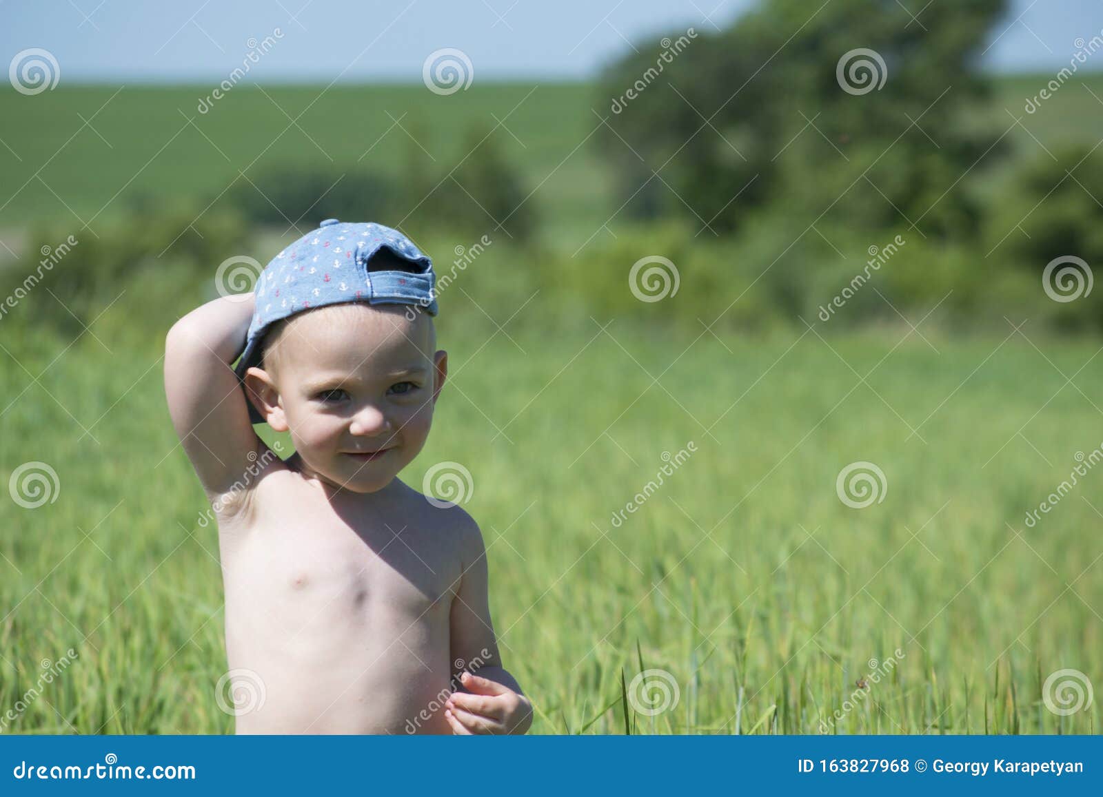 Cute Blond Child Playing in a Green Meadow among Tall Grass Stock Photo ...