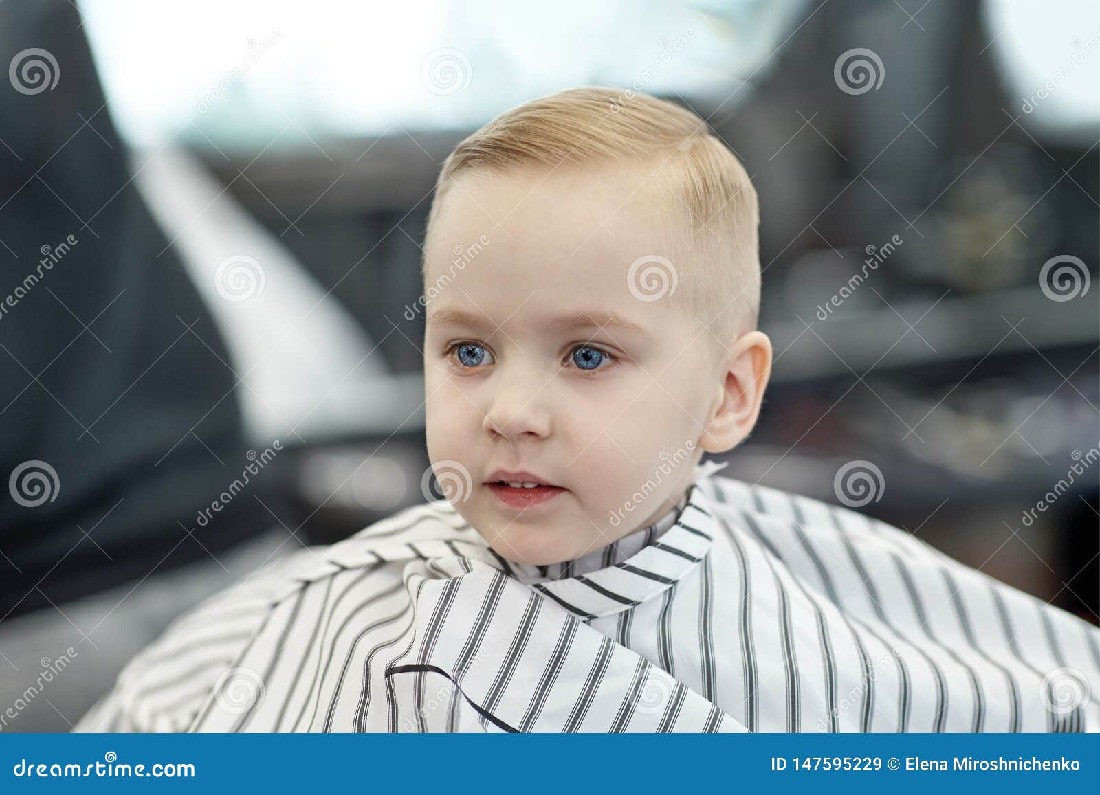 Cute Blond Smiling Baby Boy With Blue Eyes In A Barber Shop After Haircut By Hairdresser Children Fashion In Salon Stock Image Image Of Caucasian Drape