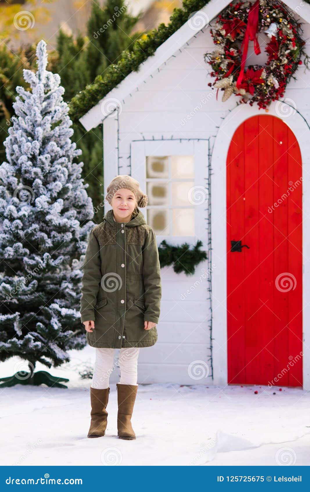 Cute Blonde Girl Near The Small House And Snow Covered Trees New Year