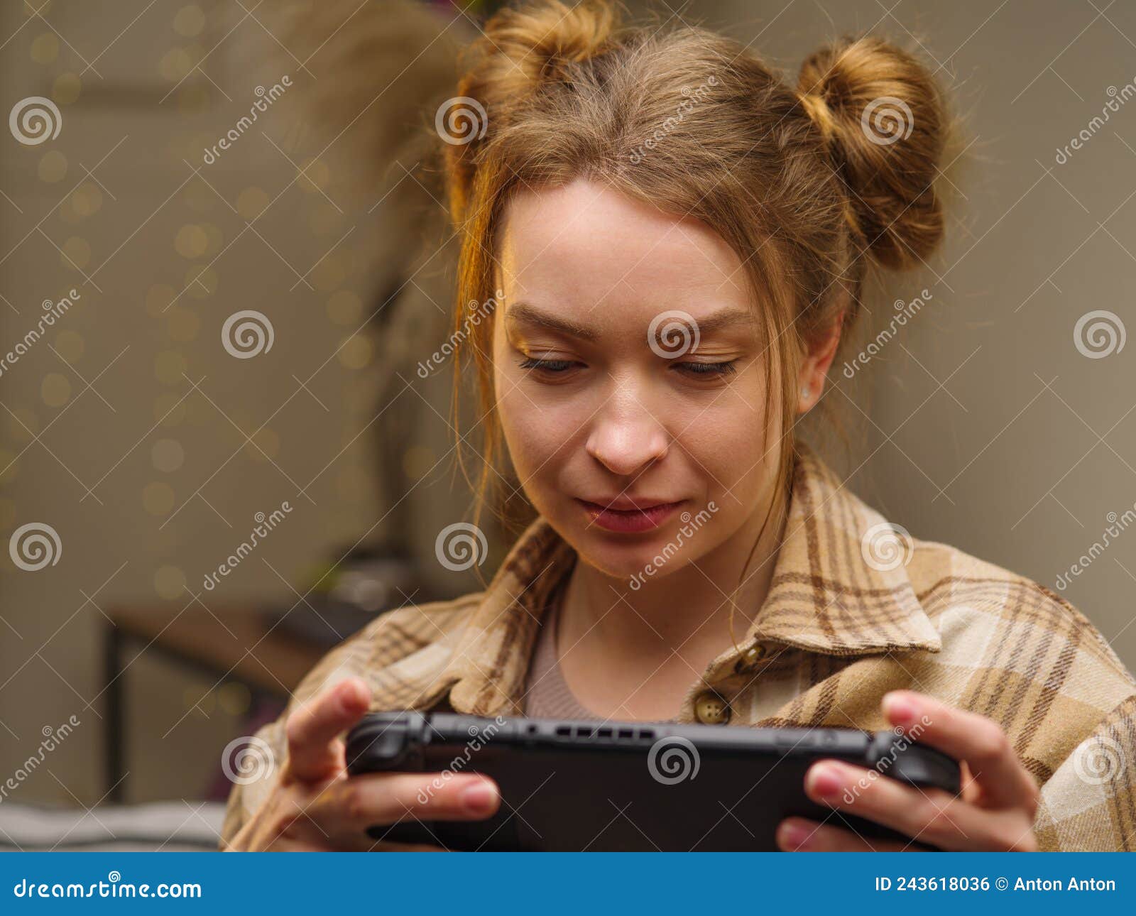 A Cute Blonde Girl Is Playing A Video Game On A Tablet In The Room