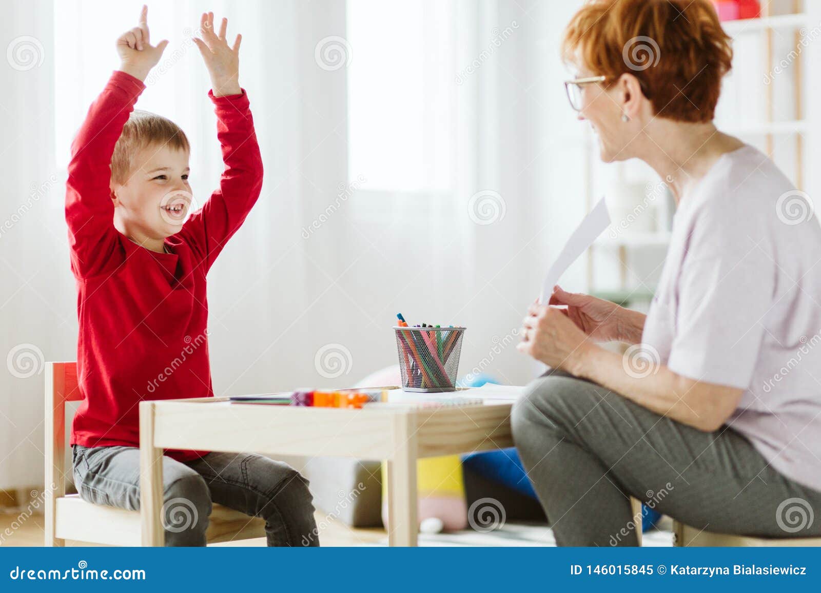 cute boy with adhd during session with professional therapist