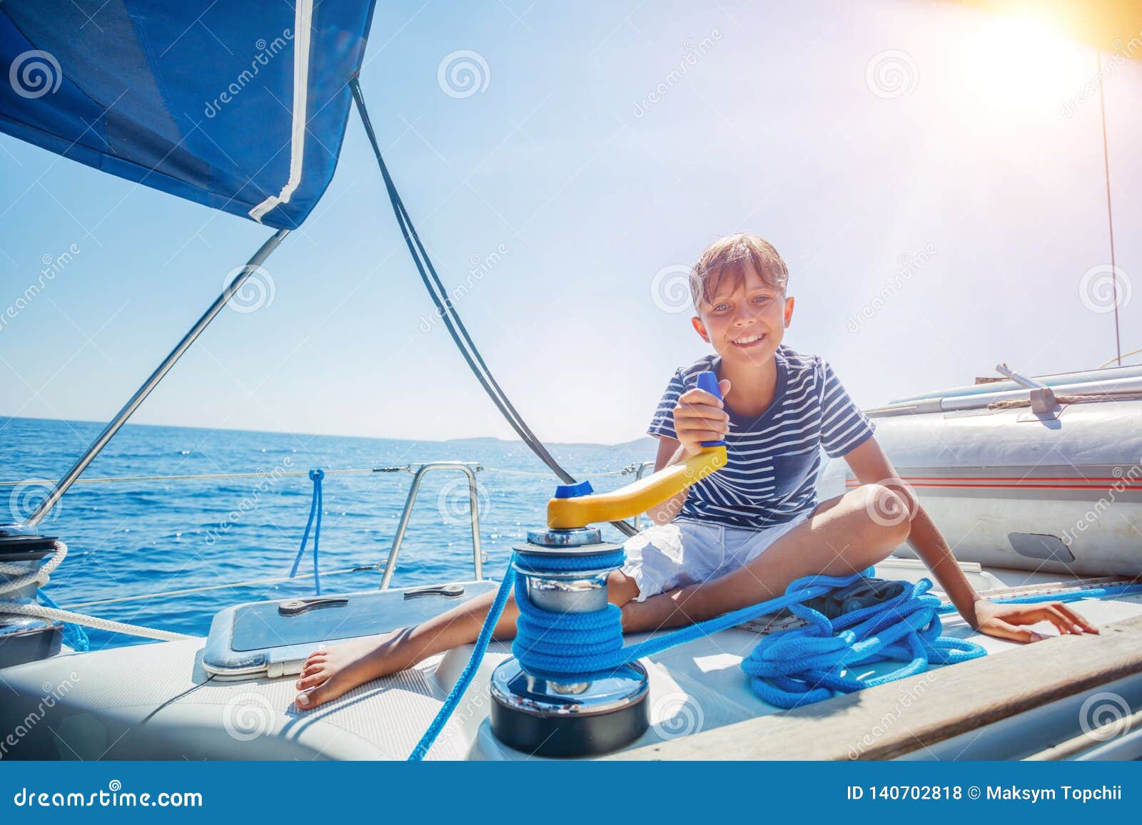 little boy on board of sailing yacht on summer cruise. travel adventure, yachting with child on family vacation.