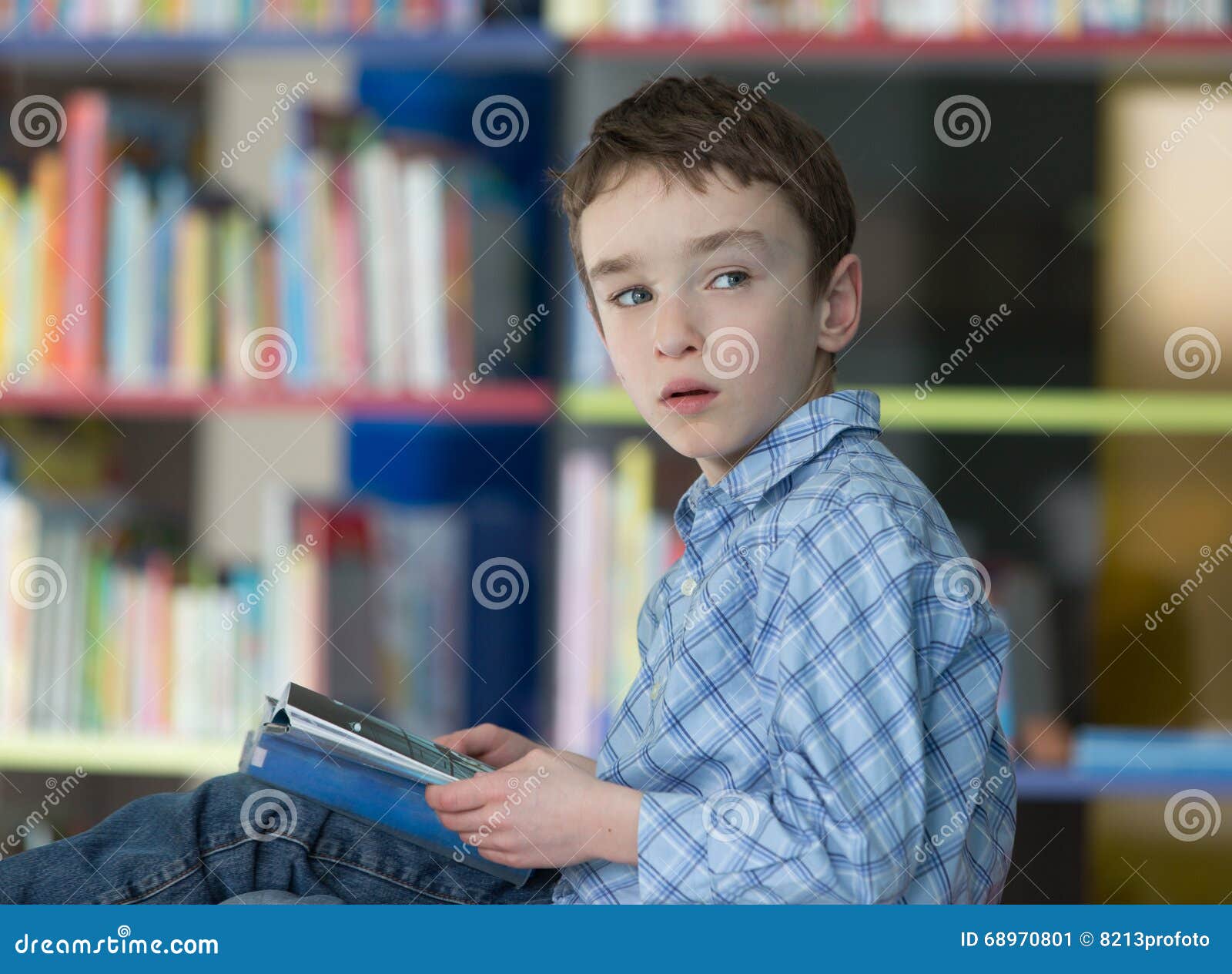 Cute Boy Reading Book in Library Stock Image - Image of bookshelves ...