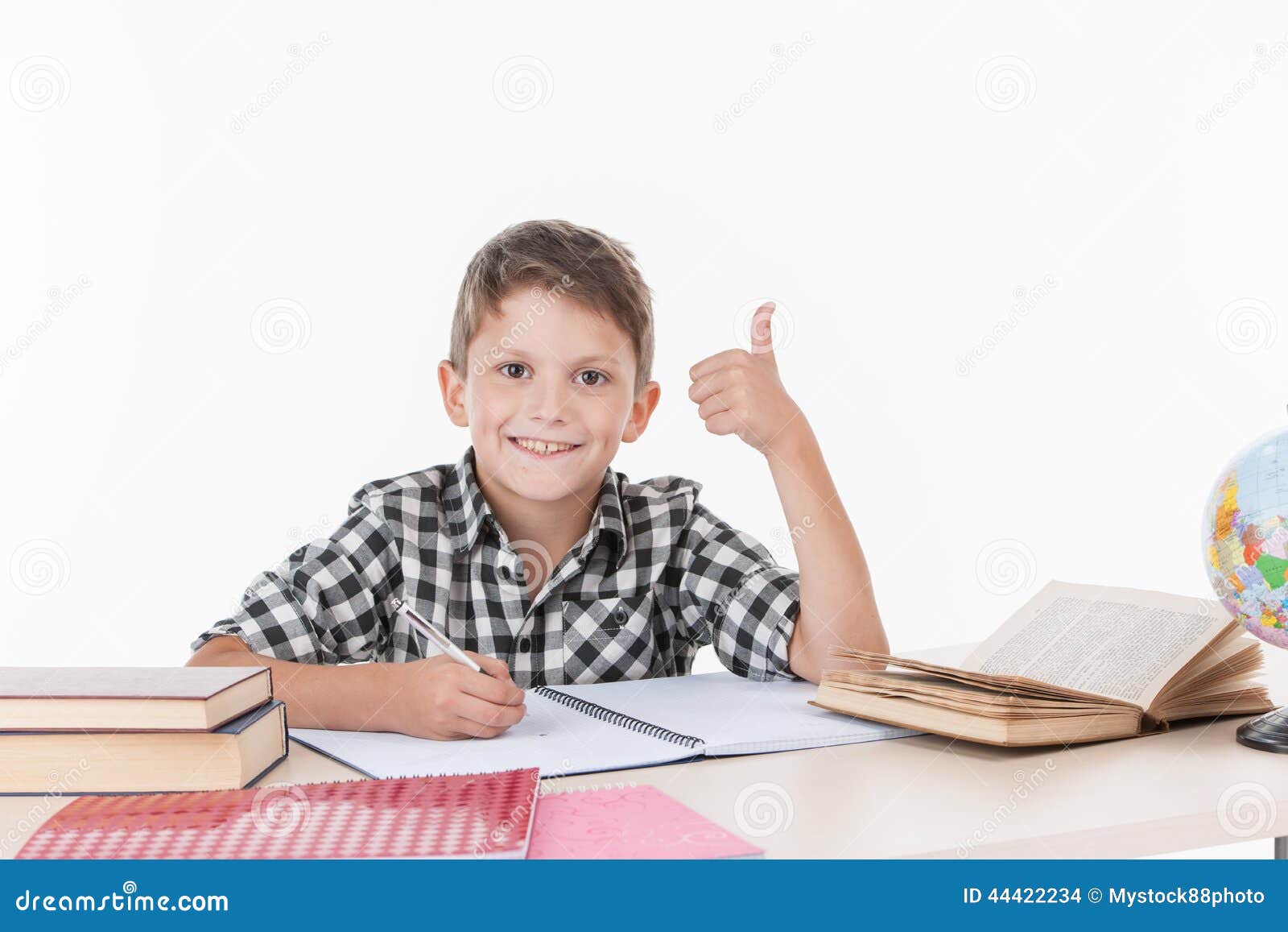 Cute Boy Sitting at Table and Writing. Stock Photo Image of