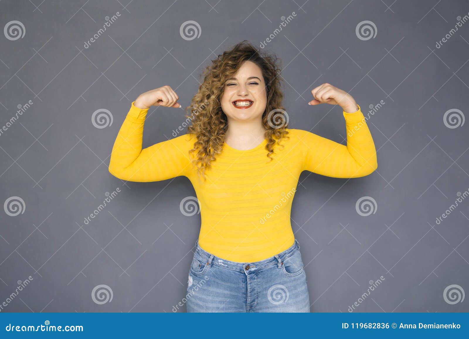 Cute Plus Size Woman with Curly Hair in Yellow Sweater Stock