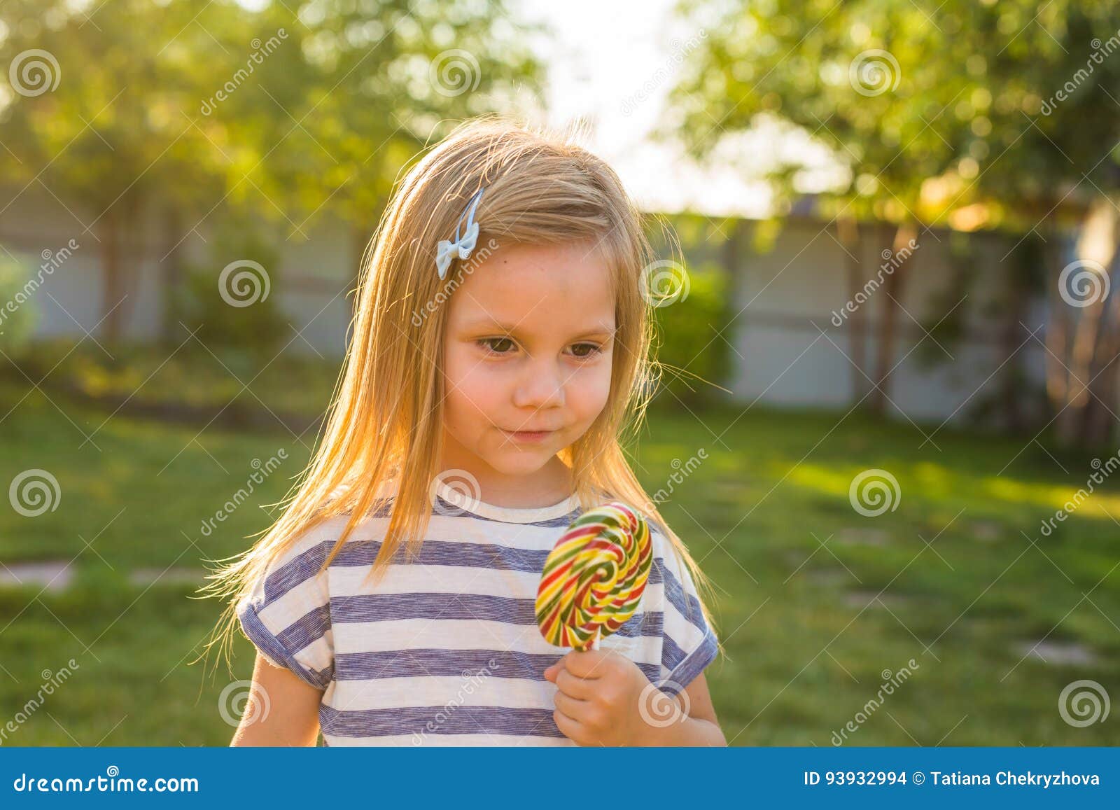 cute cauasian baby girl and big lollipop