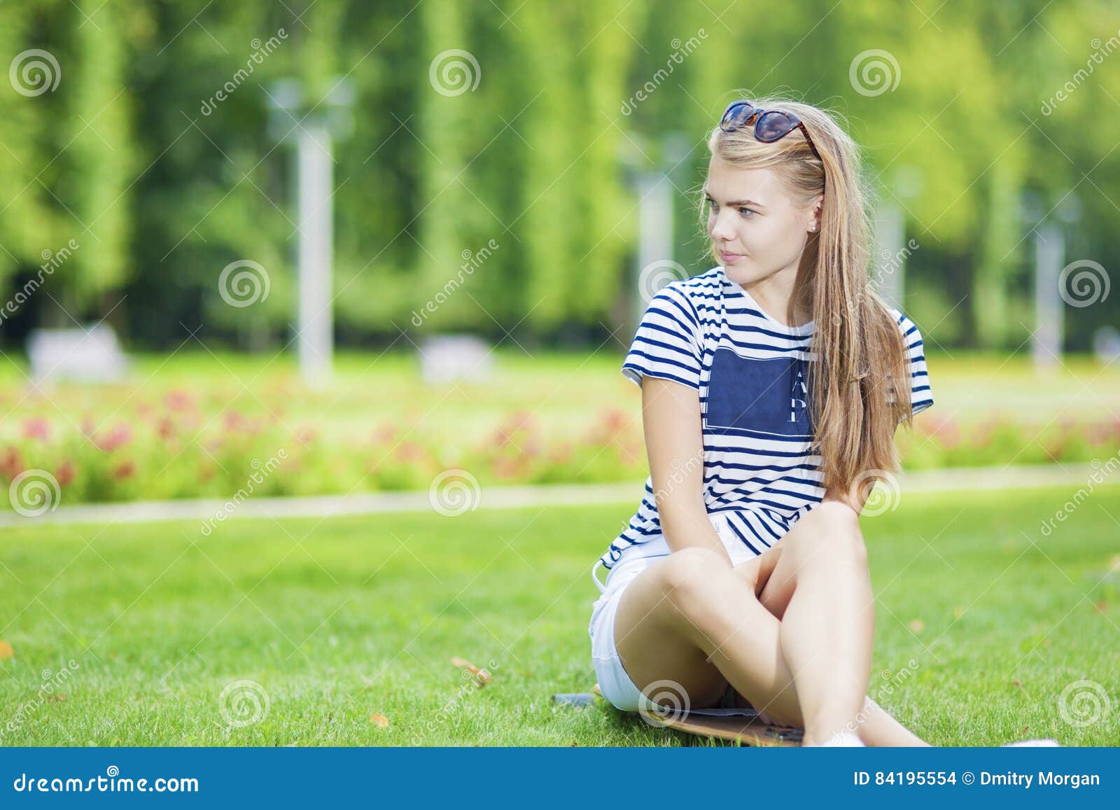 Cute Caucasian Blond Teenage Girl with Longboard in Green Summer Park ...