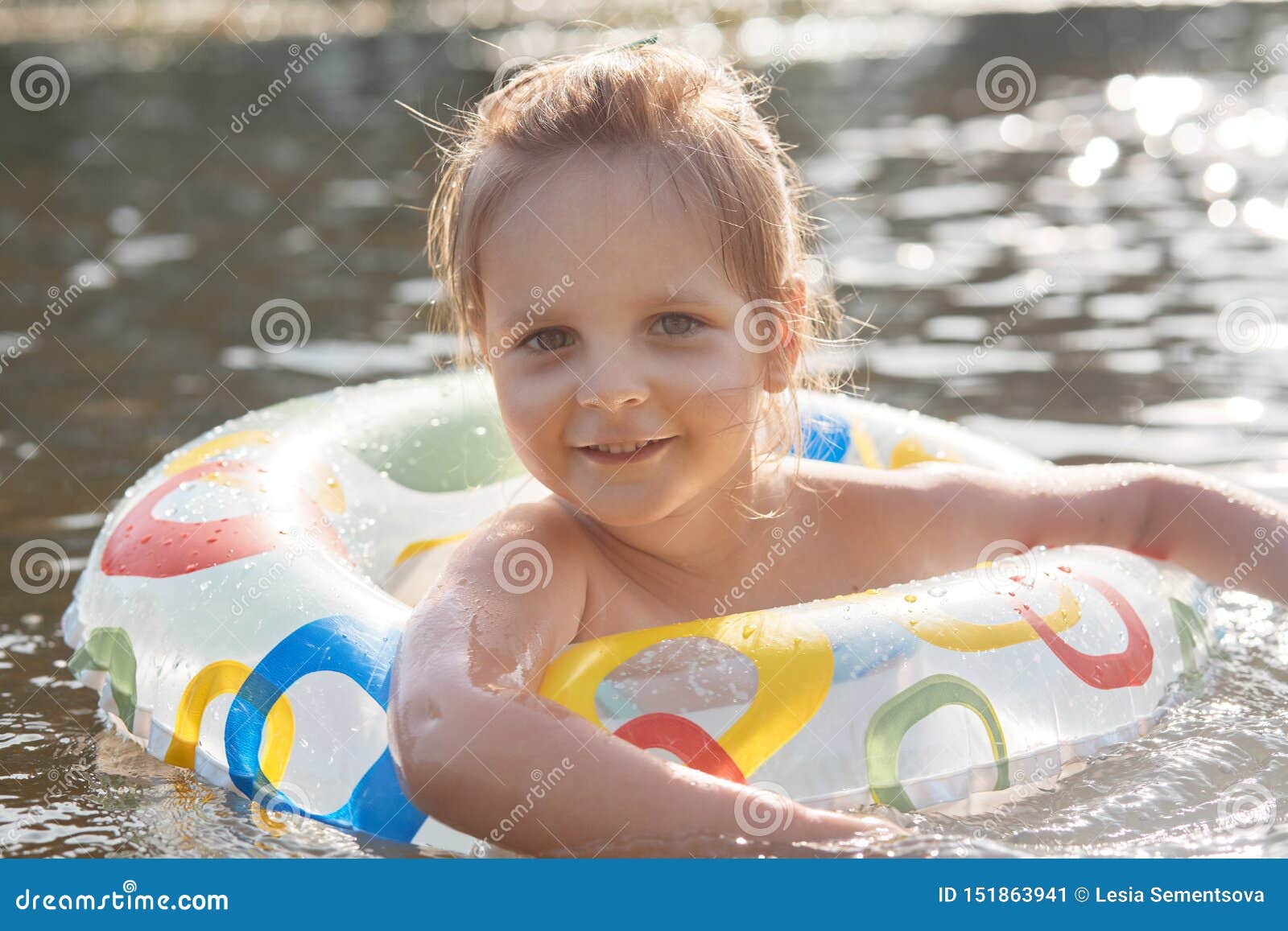 Cute Caucasian Child Girl Playing in Water with Inflatable Ring ...