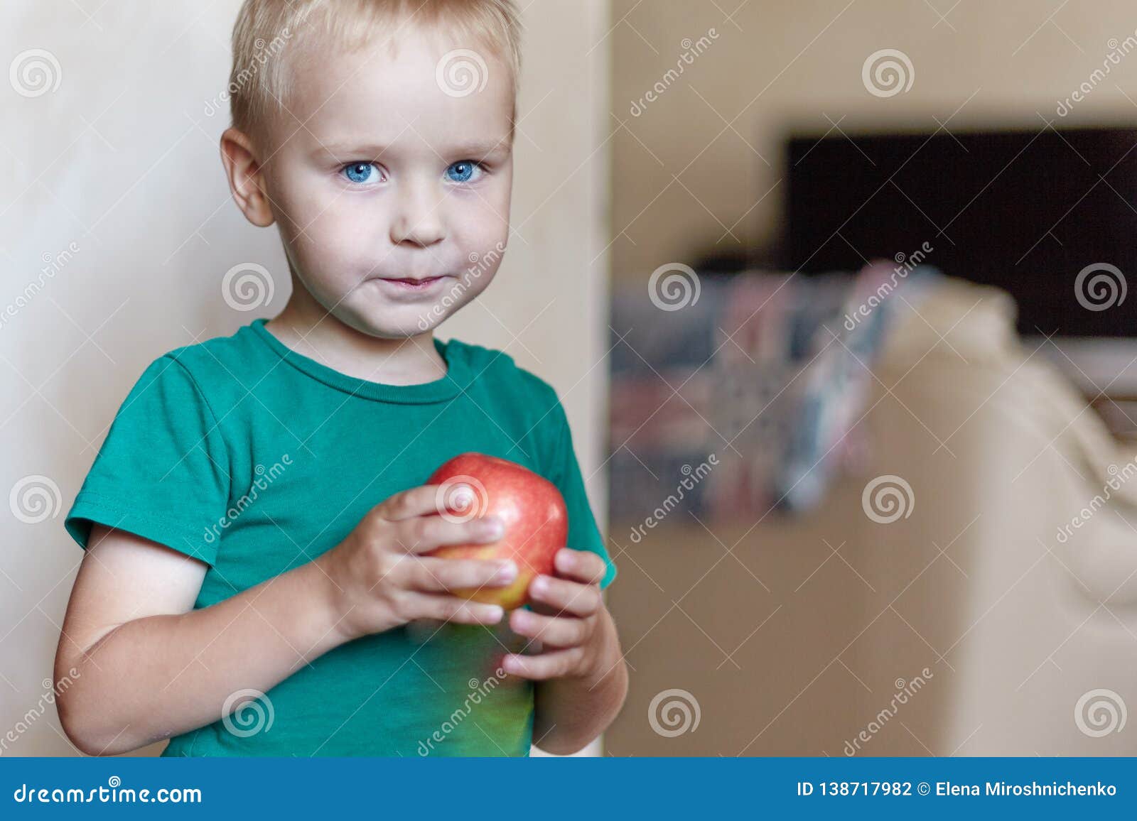 Cute Caucasian Little Boy With Blue Eyes And Blonde Hair In Green