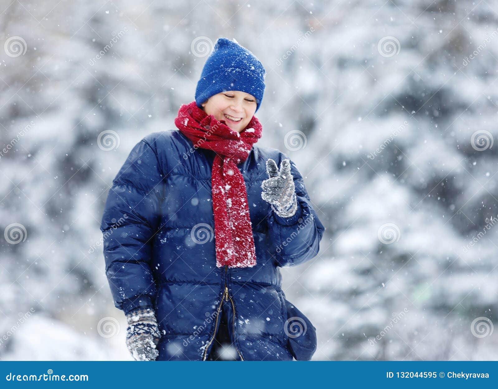 Cute, Cheerful Young Boy in Hat, Blue Jacket Plays with Snow, Has Fun ...