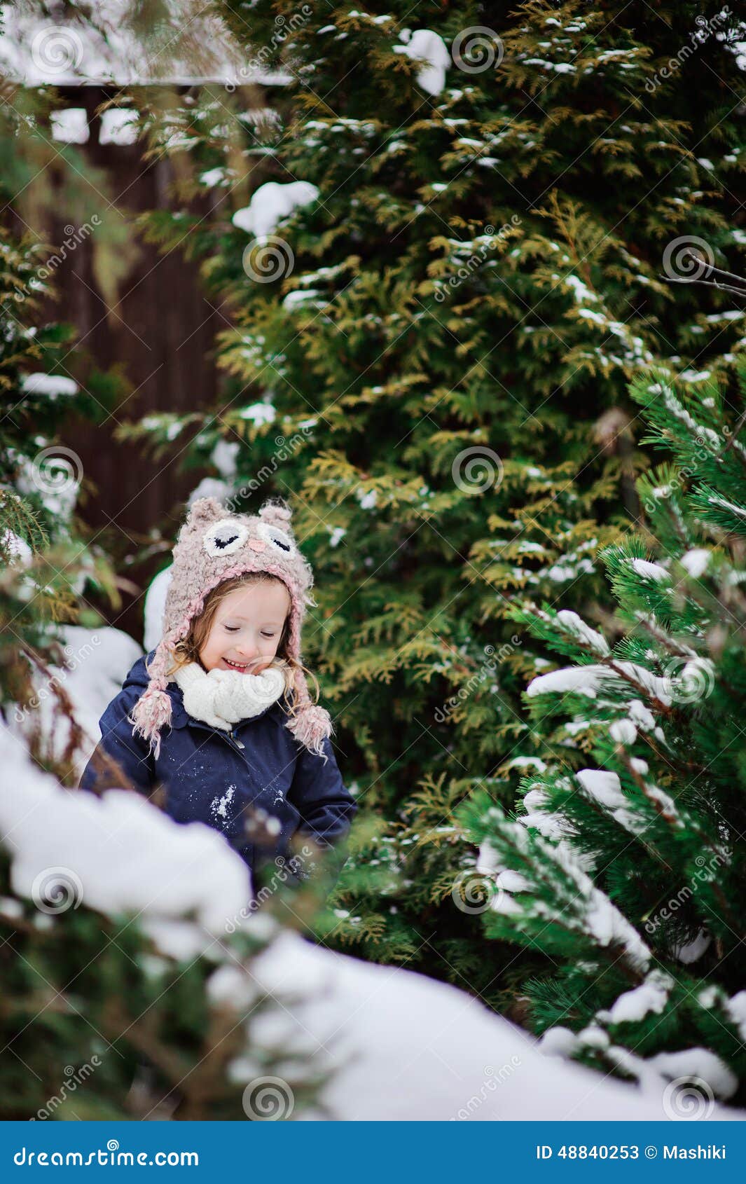 Cute Child Girl In Owl Knitted Hat On The Walk In Winter Snowy