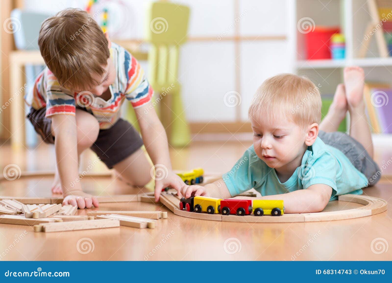 Cute Baby Boy Confident Playing Railroad Train Toy On Sand Table