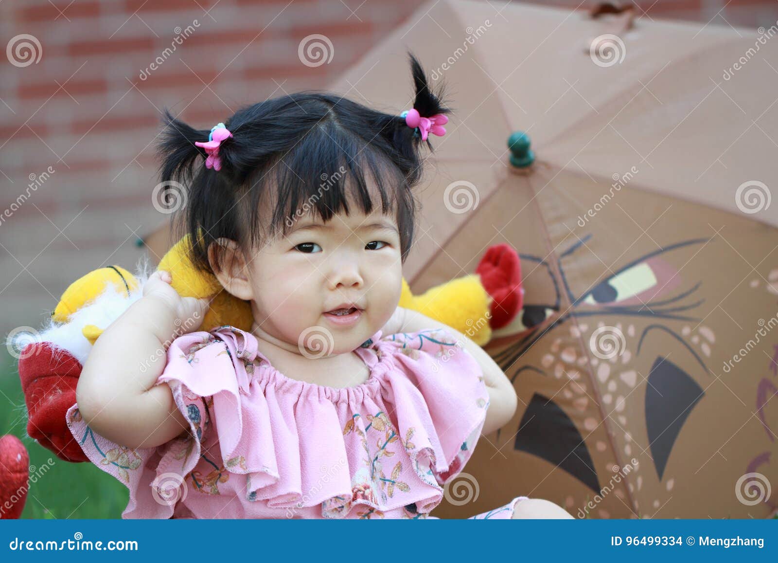 Cute Chinese Baby Girl Play Plush Toy On The Lawn Stock Photo Image