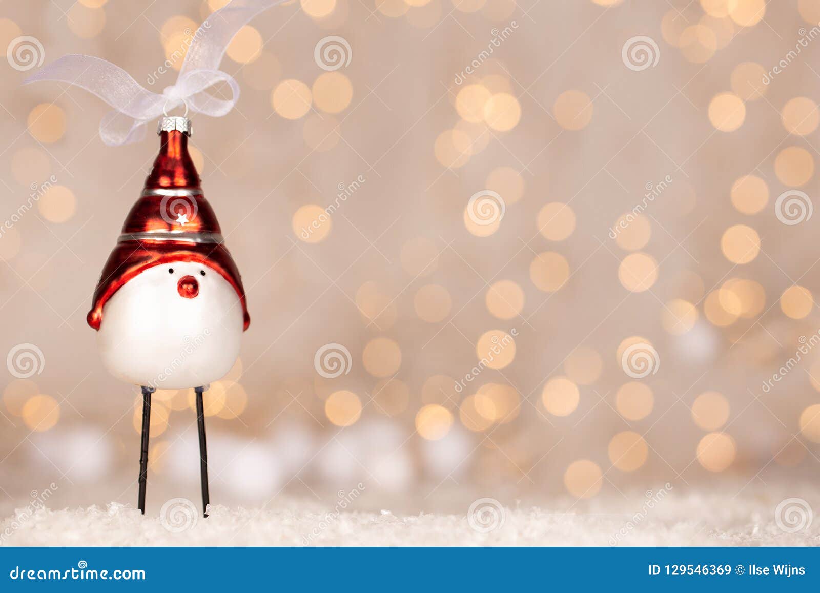 cute christmas bird adornment with bokeh of yellow and white christmas lights