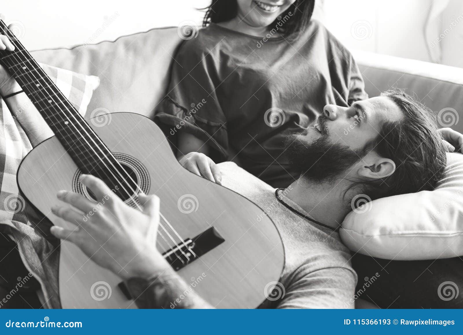 Cute Couple on a Couch Boyfriend Playing a Guitar Music and Love ...