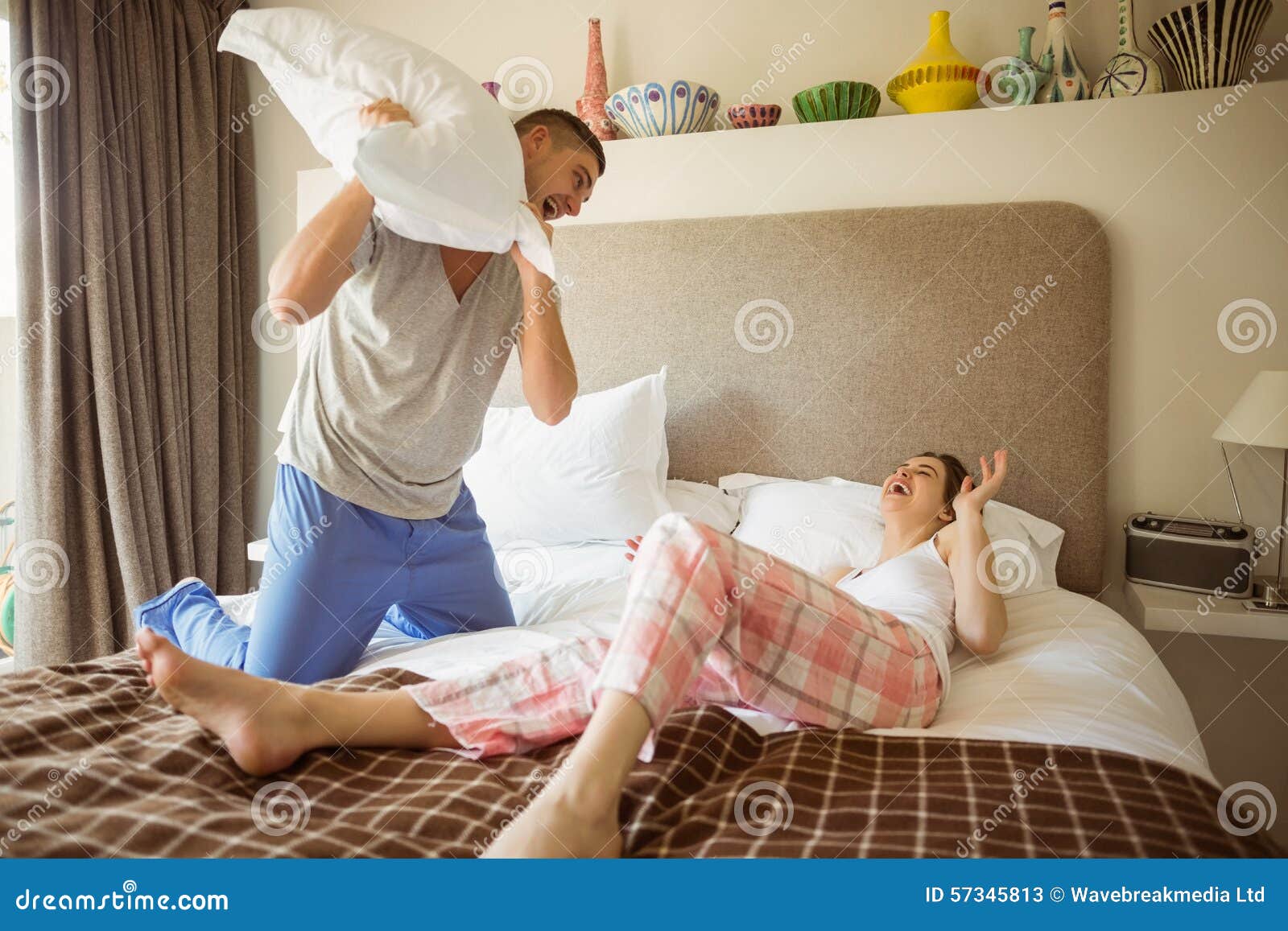 Cute Couple Having A Pillow Fight Stock Image Image Of Domicile Male 57345813