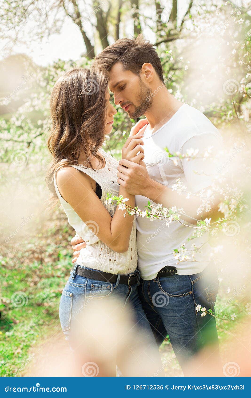 Cute Couple Touching Each Other in the Blooming Garden Stock Photo ...