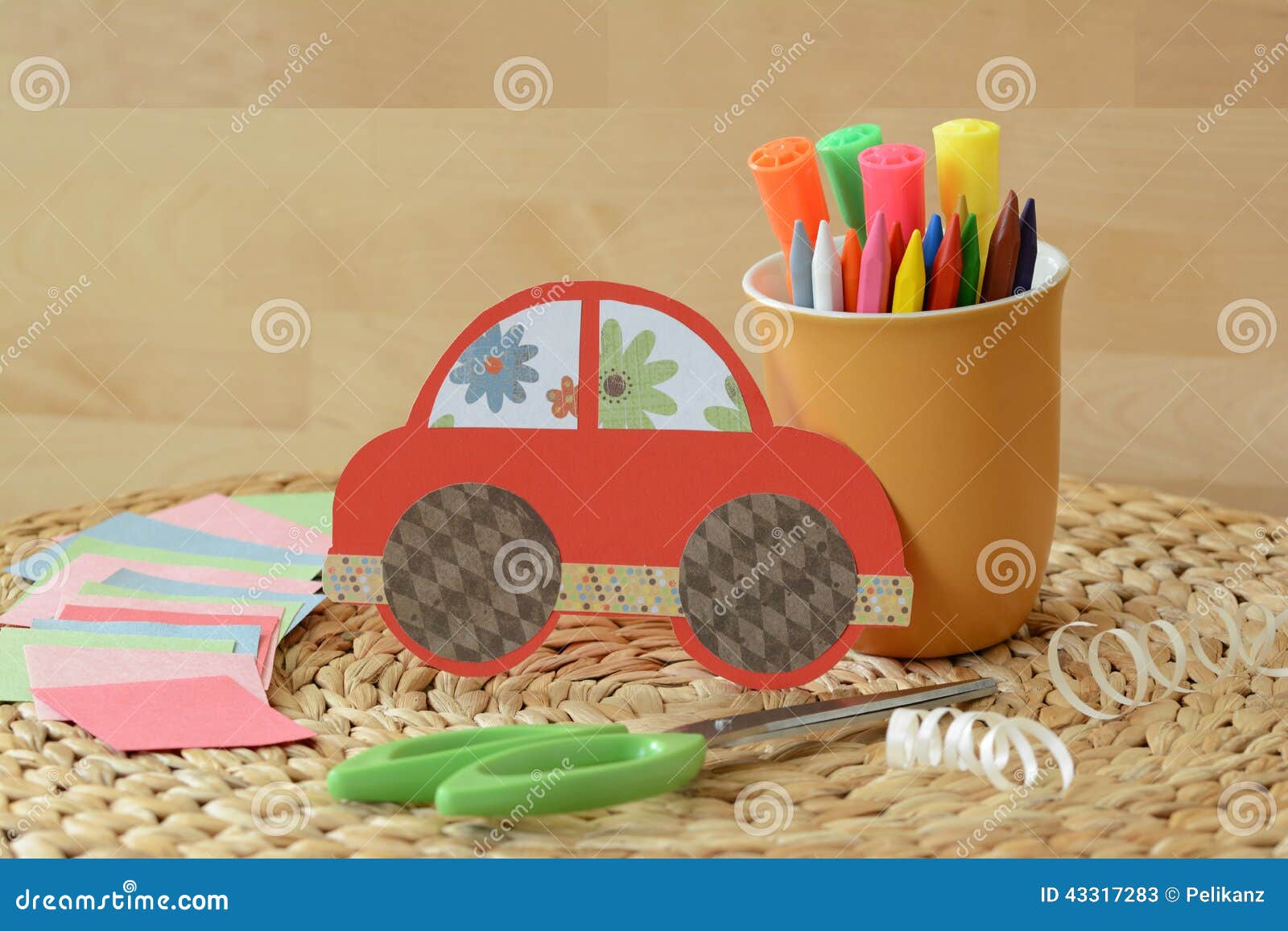 cute crafty hand made red car for kids with colorful pastels and scissors