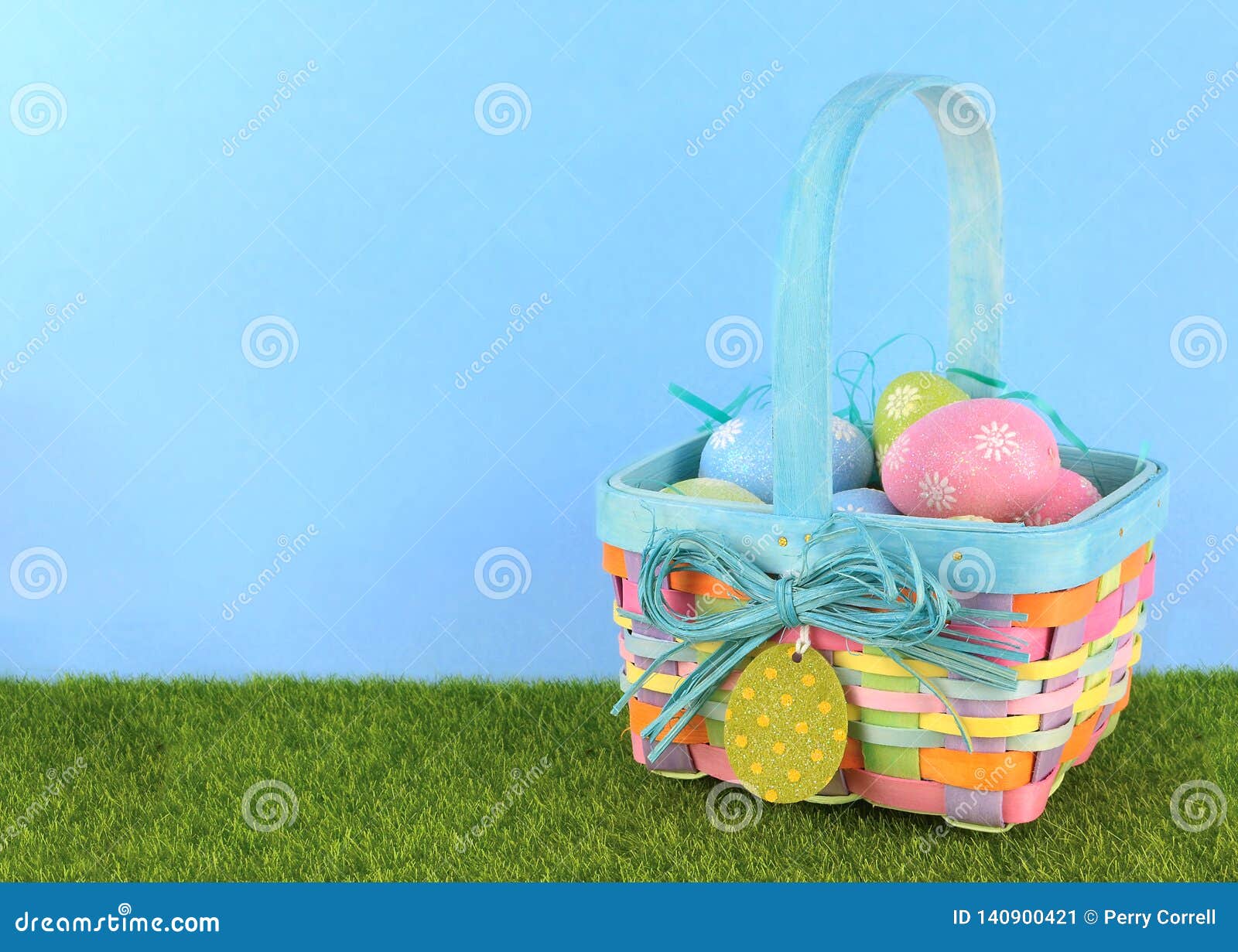 Cute Easter Image with Green Grass and Blue Sky with Colorful Easter