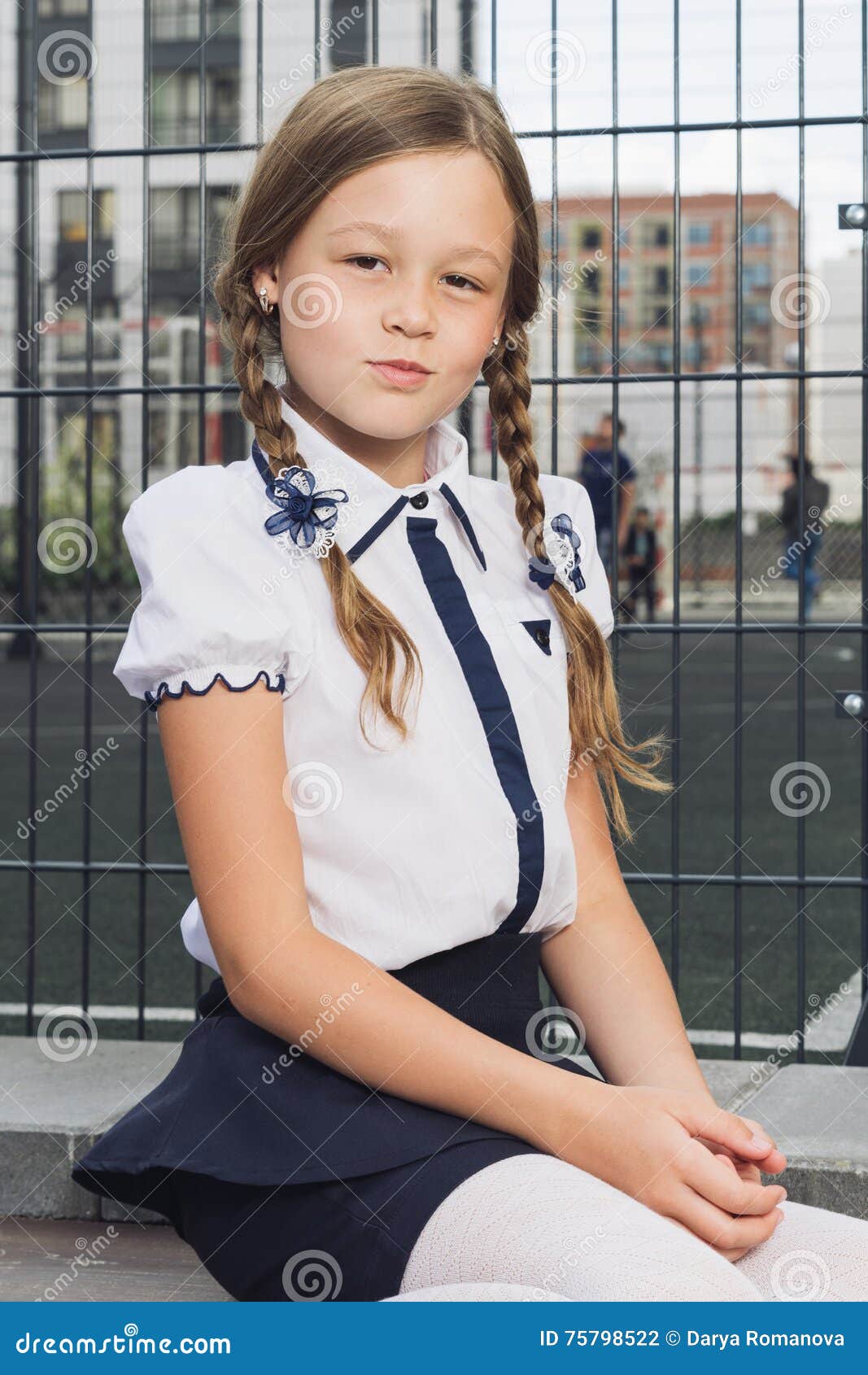 cute ary schoolgirl in uniform at playground