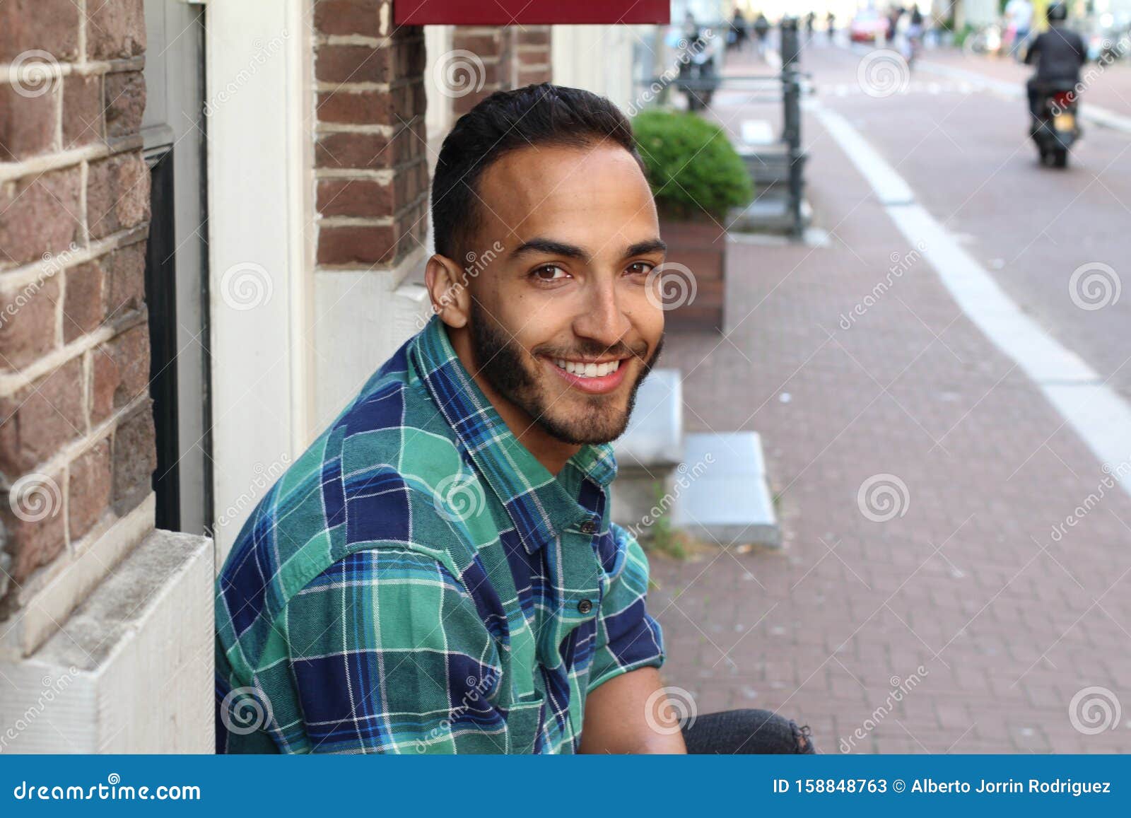 Cute Ethnic Man Sitting at Home Entrance Stock Image - Image of ...