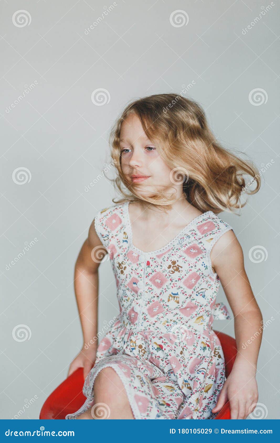Cute European Teen Girl on a Gray Background Sitting on a Red Chair ...