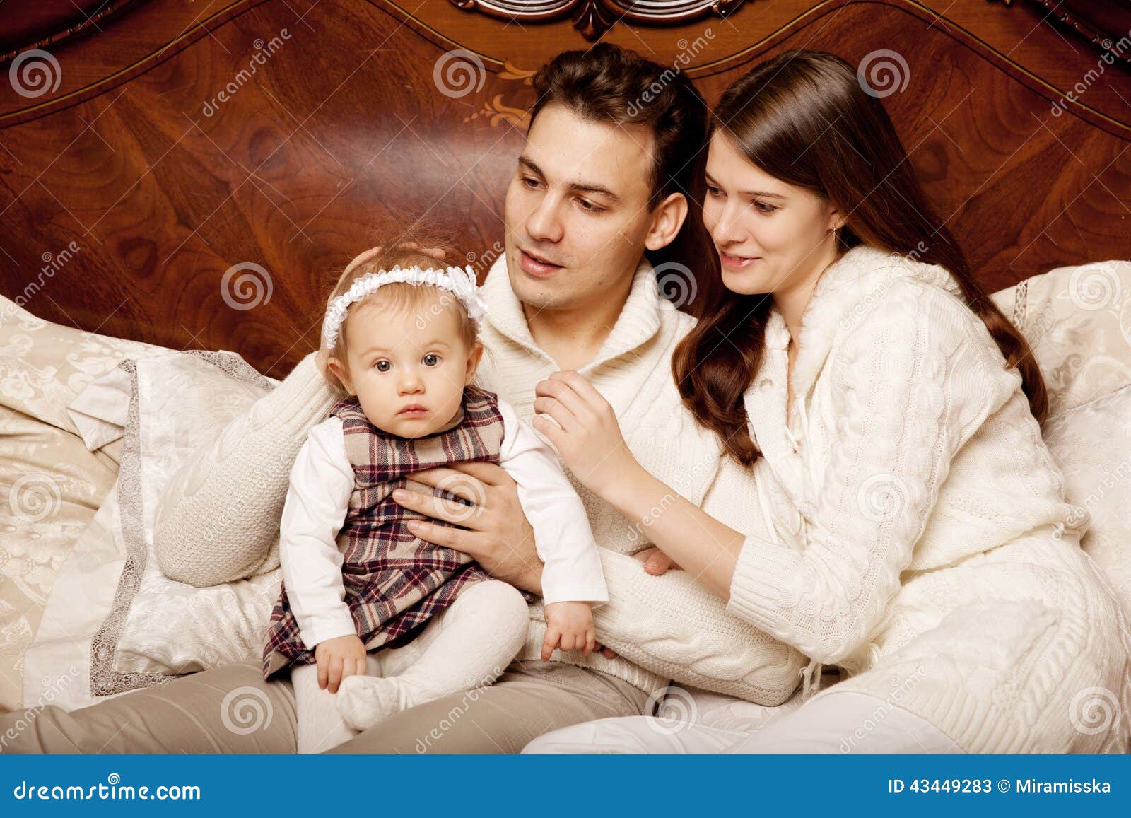 Cute Family in the Bedroom. Mother, Father and Daughter in the I ...