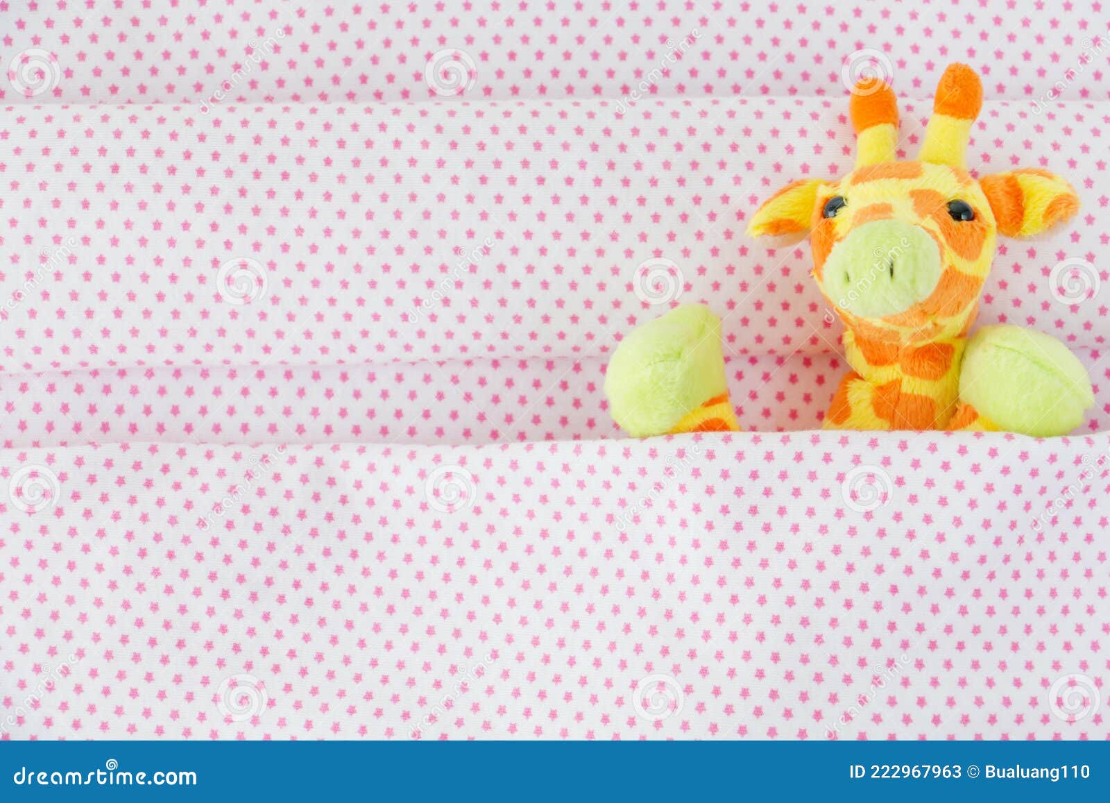 Cute Giraffe Lying Down on the Bed with Pink Blanket Stock Image