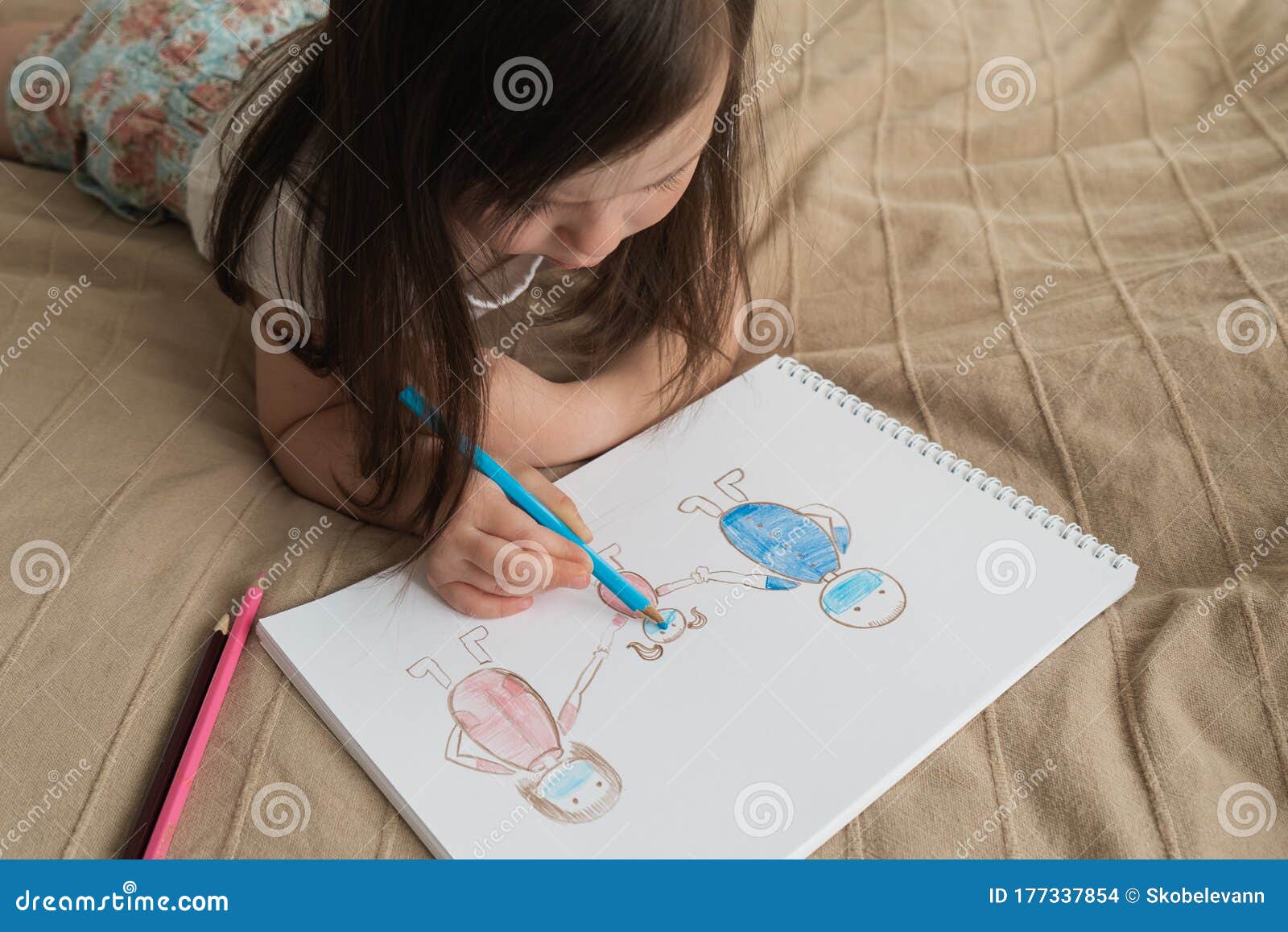 Cute Girl Draws a Pencil Drawing. a Child Learns To Draw People ...