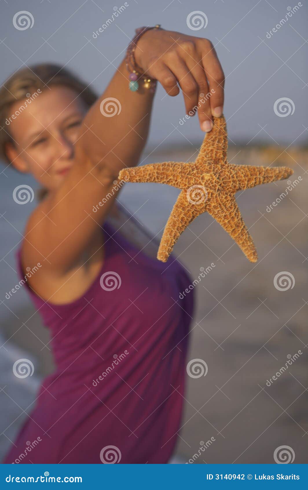 cute girl is holding seastar
