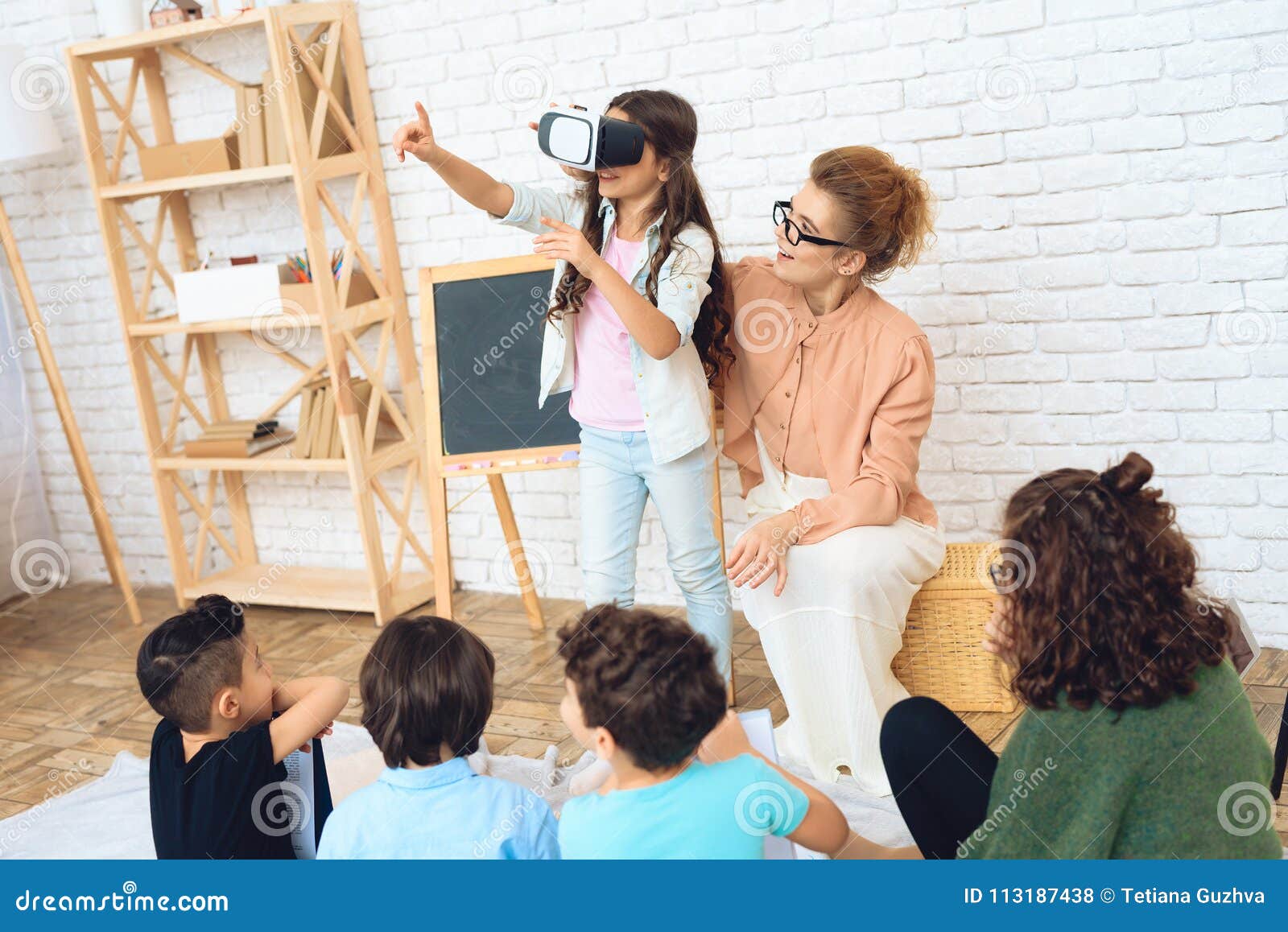 Cute Girl Looks Into Virtual Reality Glasses At Classroom