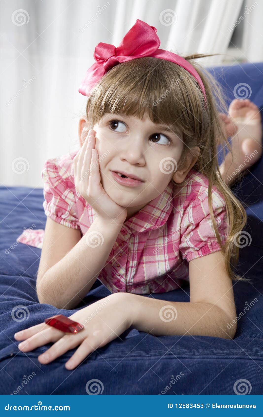 Cute girl lying on sofa stock image. Image of children 12583453