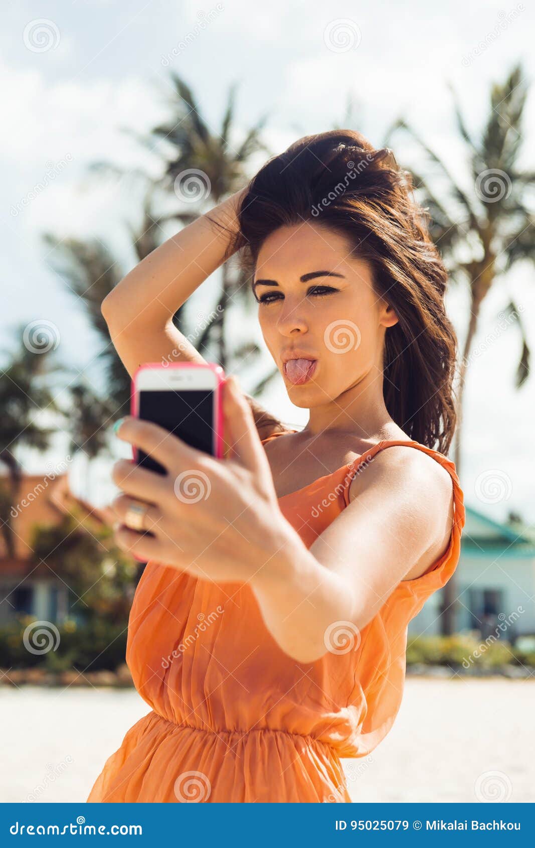 cute girl make selfie tropical beach close up sexy lady light dress sunglasses posing tongue self portrait 95025079