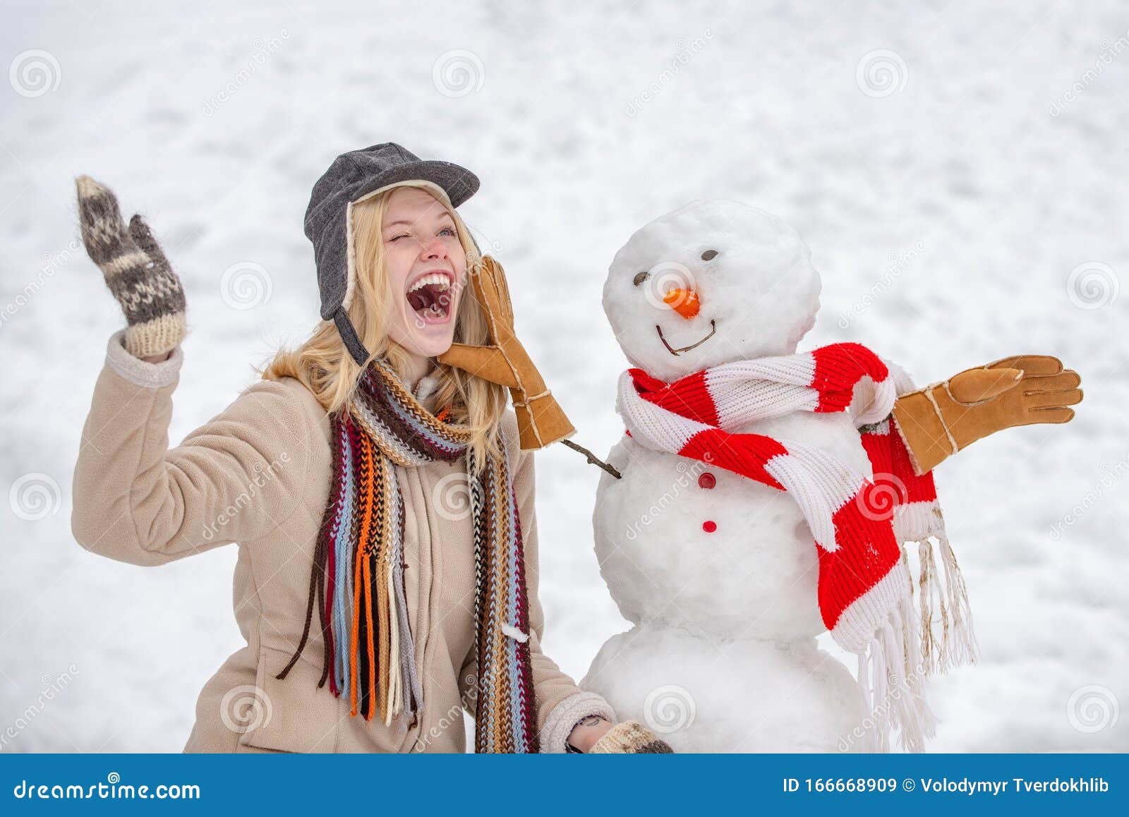 Cute Girl Making Snowman on Snowy Field Outdoor. Funny Winter Girl ...