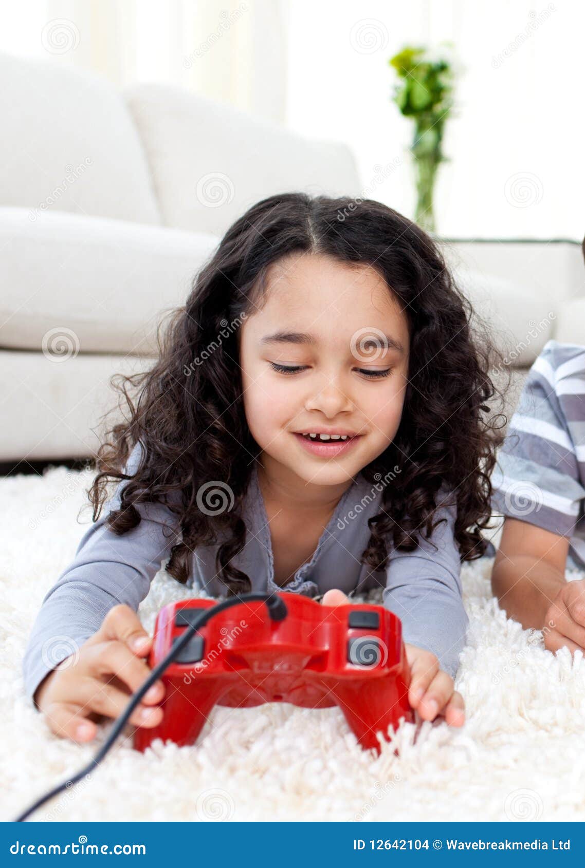 Cute Girl Playing Video Games Lying On The Floor Stock Imag