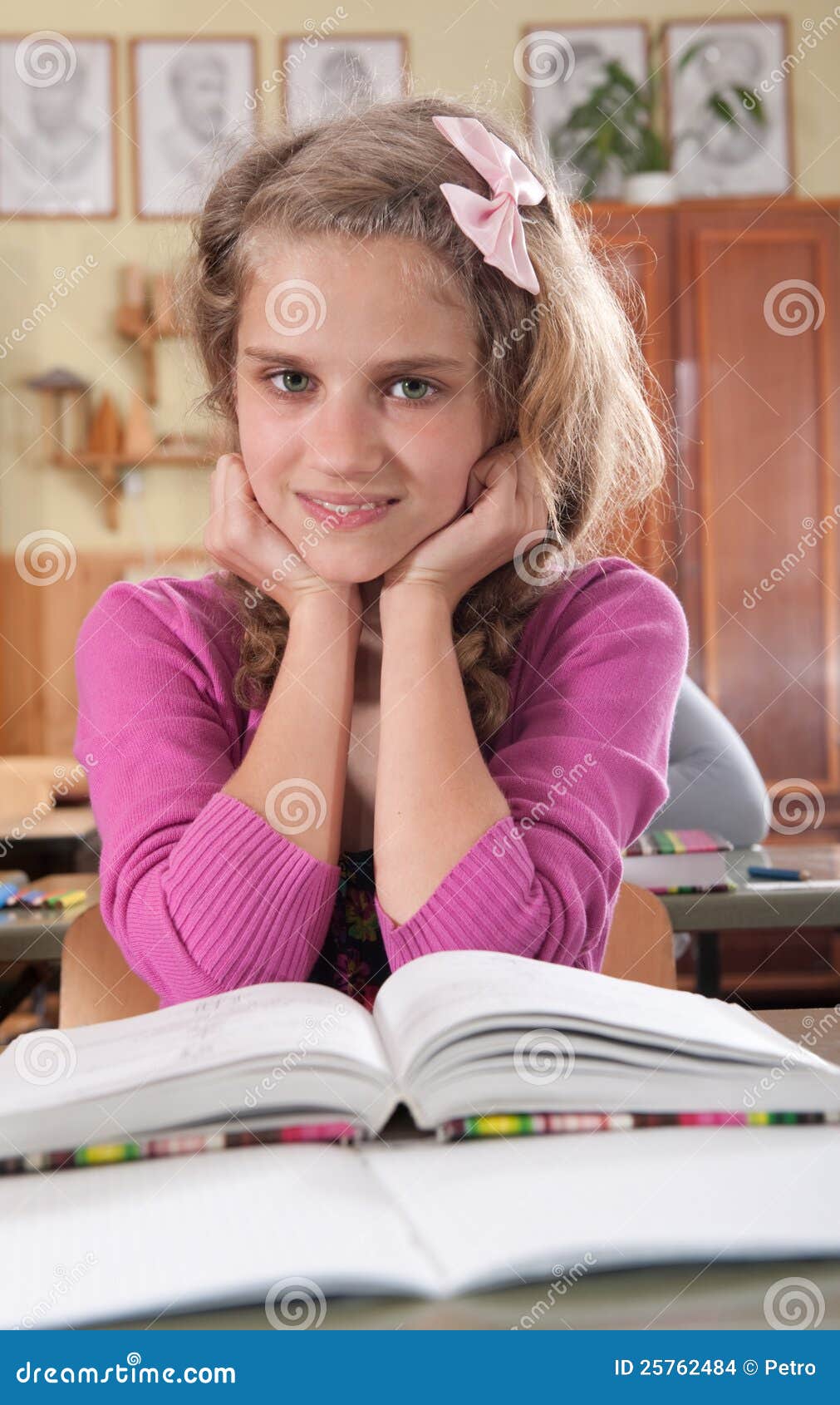 Cute Girl Reading Book In Classroom At School Stock Images